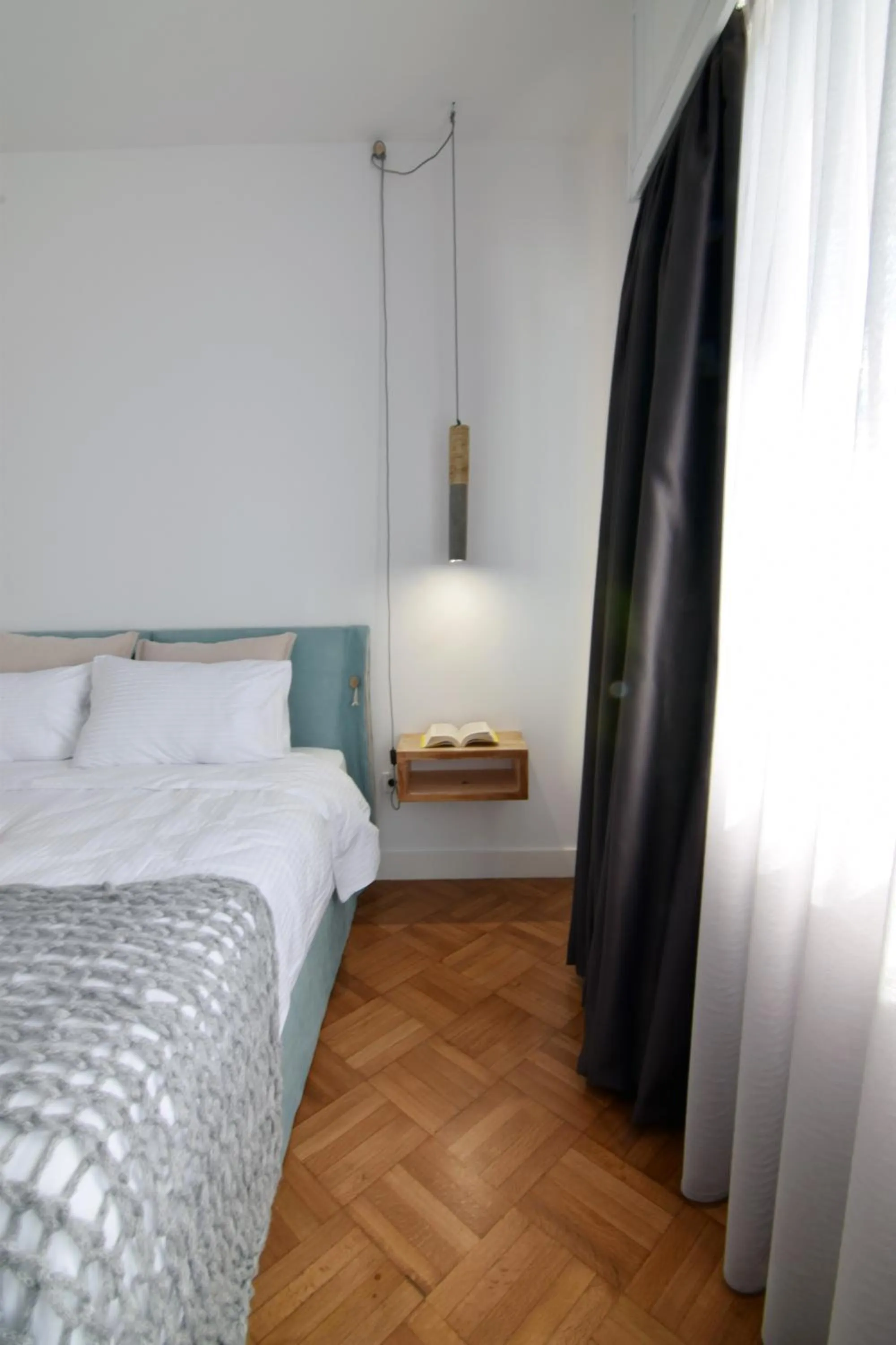 Bed in Grey Studios by Skg Apartments