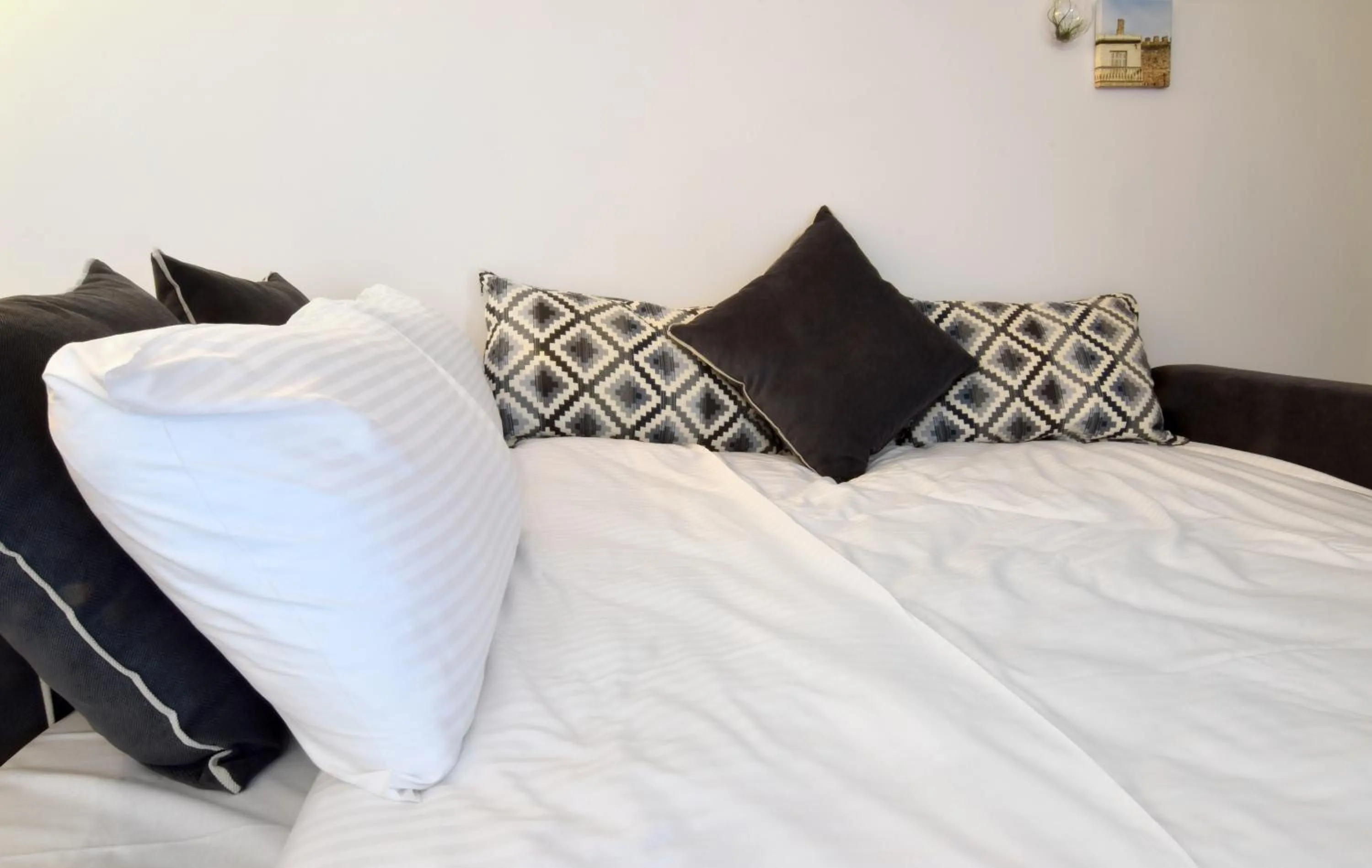 Bed in Grey Studios by Skg Apartments