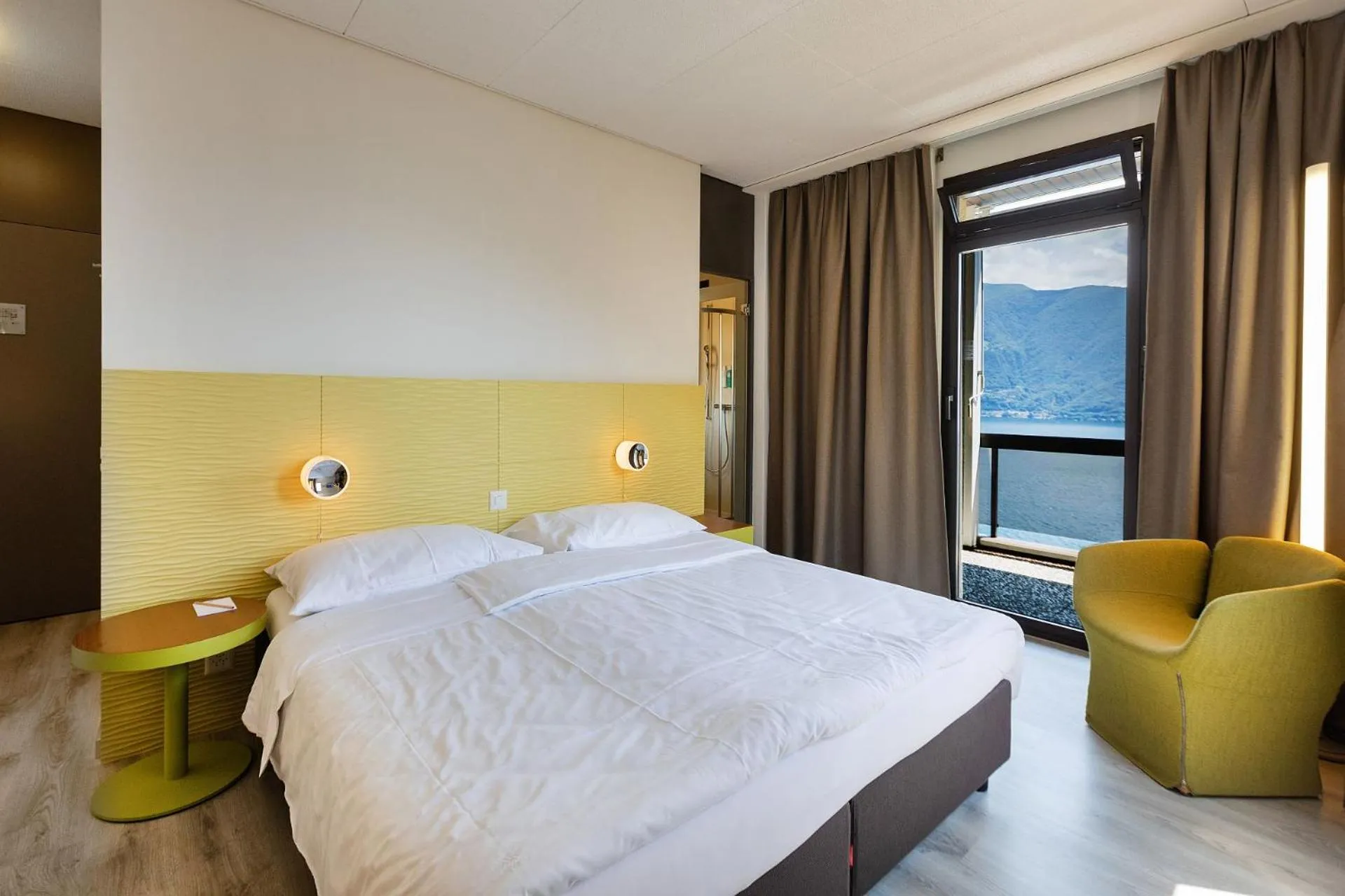 Photo of the whole room, Bed in Parkhotel Brenscino Brissago