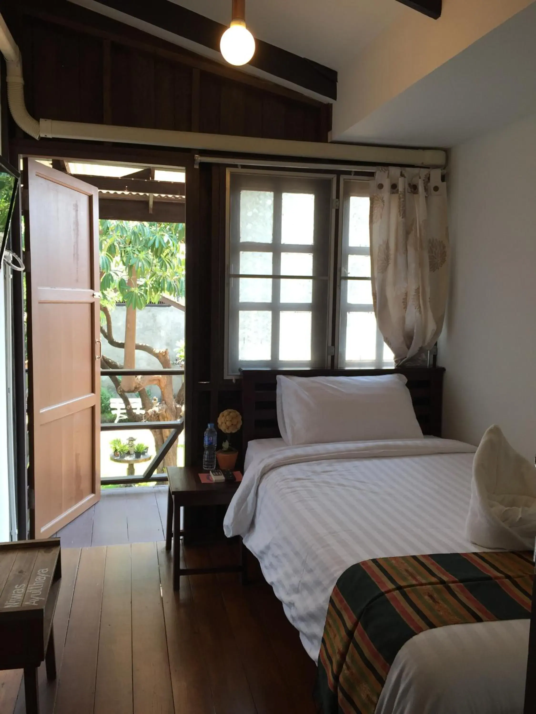 Standard Single Room with Balcony and bathroom outside bedding unit in Niwas Ayutthaya Standard Single Room with Balcony and bathroom outside bedding unit in Niwas Ayutthaya