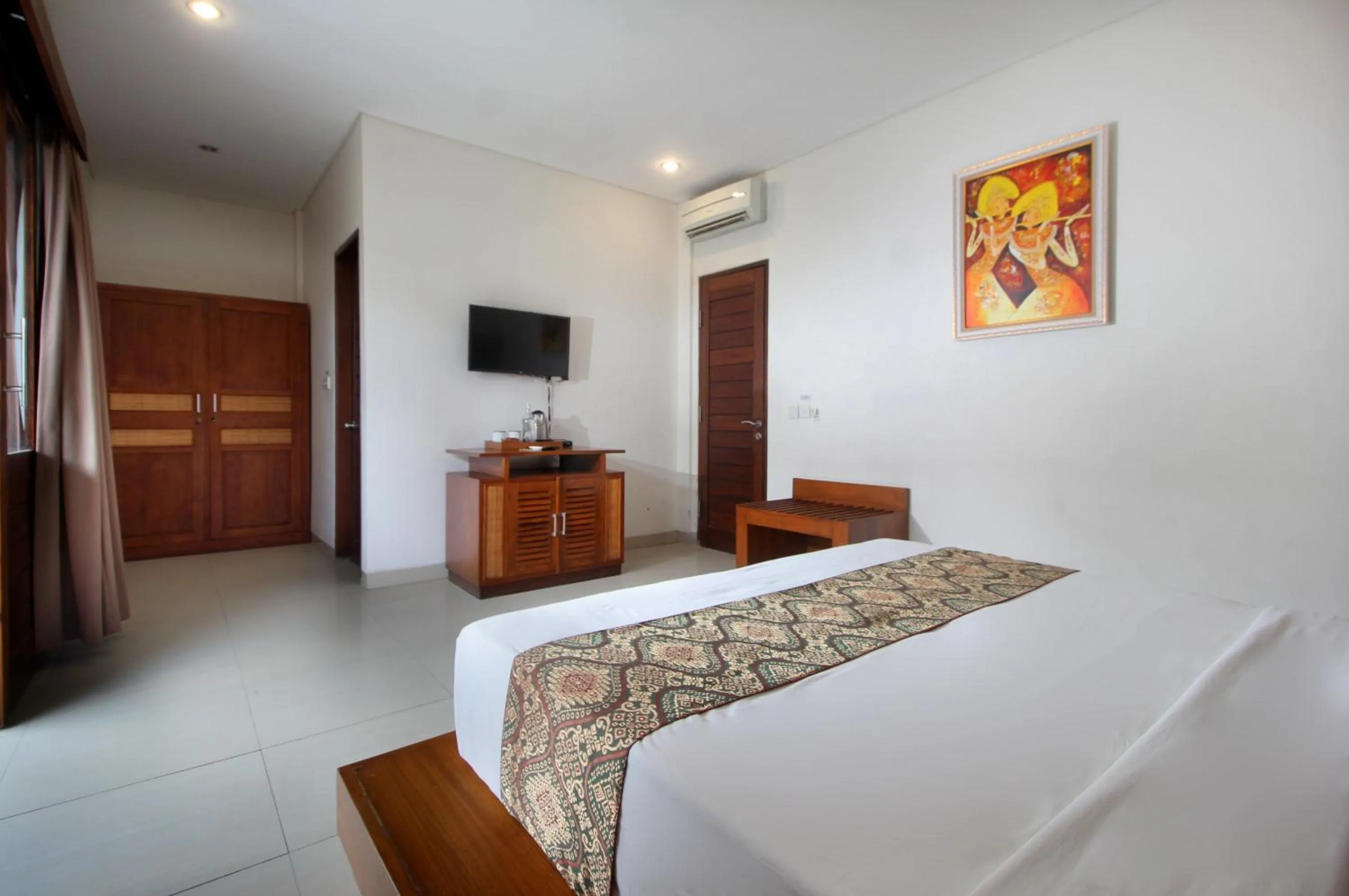 Bed in Putri Ayu Cottages