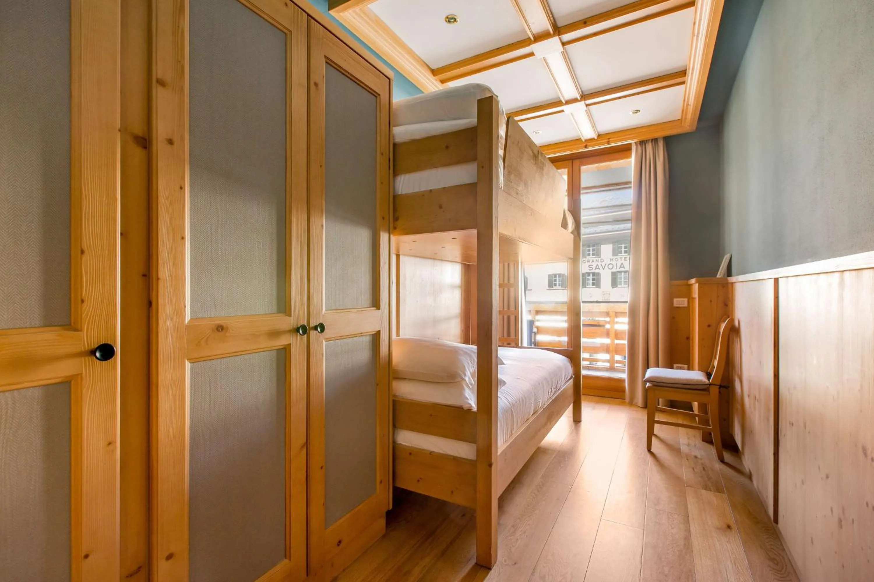 Photo of the whole room, Bed in Radisson Residences Savoia Palace Cortina d’Ampezzo