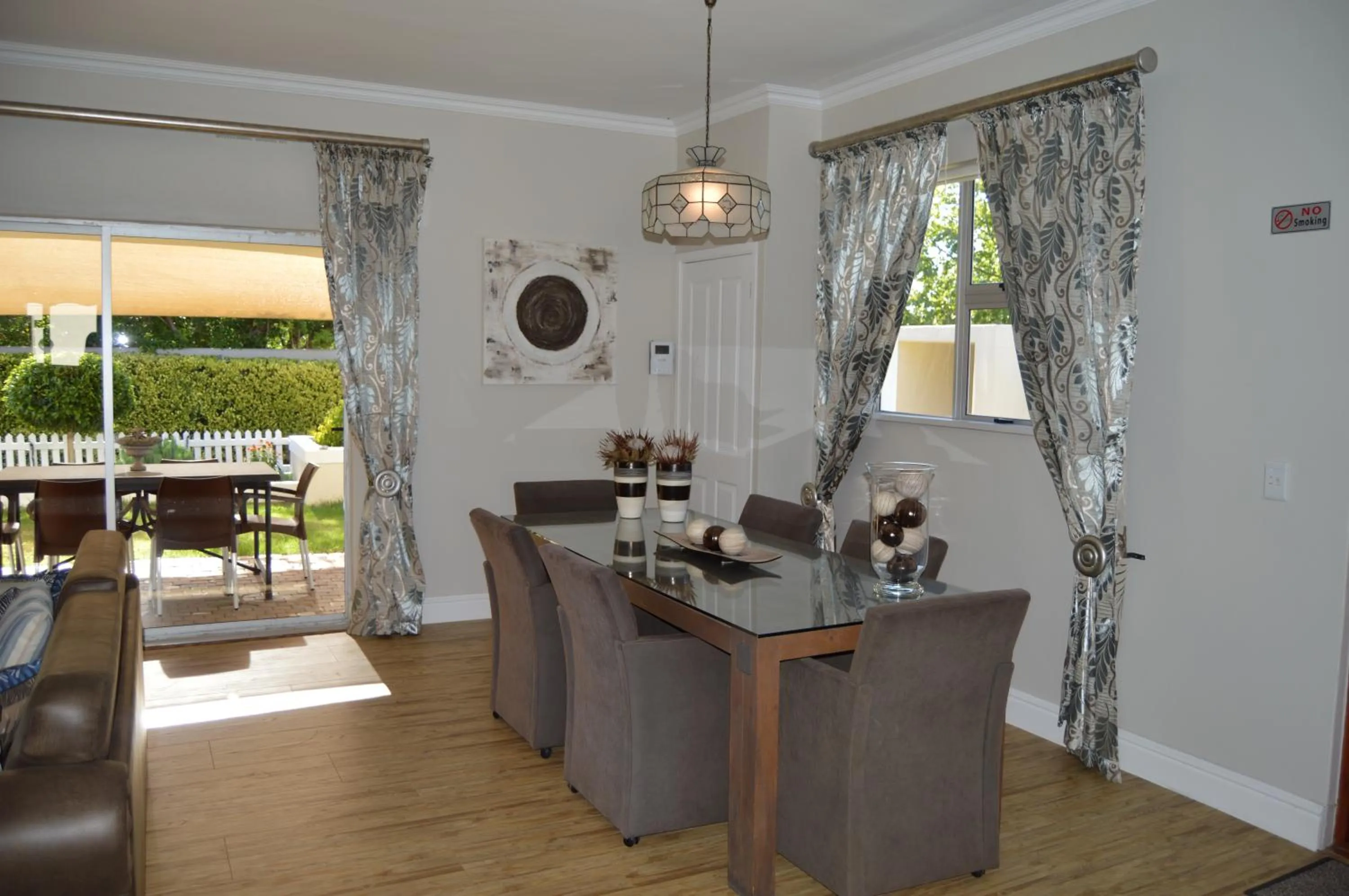 Communal lounge/ TV room in African Palm Cottage and Guesthouse