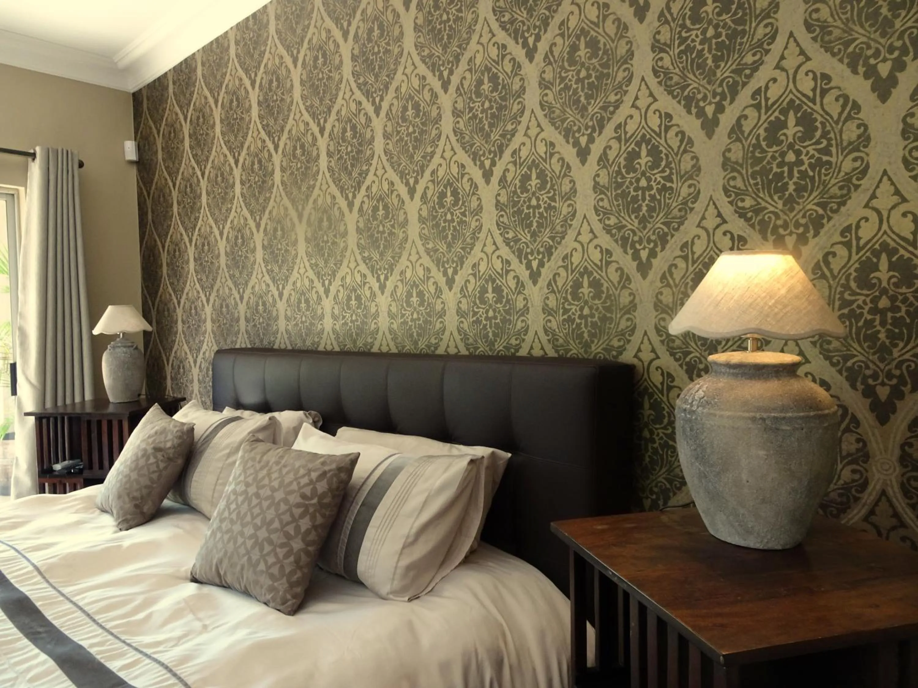 Bedroom in African Palm Cottage and Guesthouse