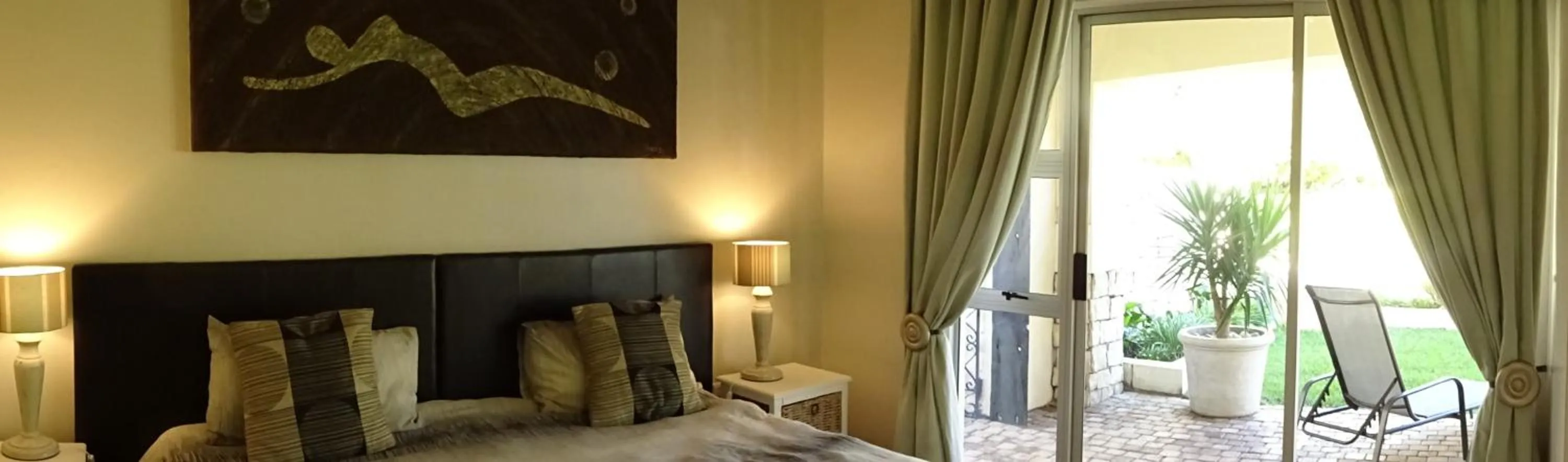 Bedroom in African Palm Cottage and Guesthouse