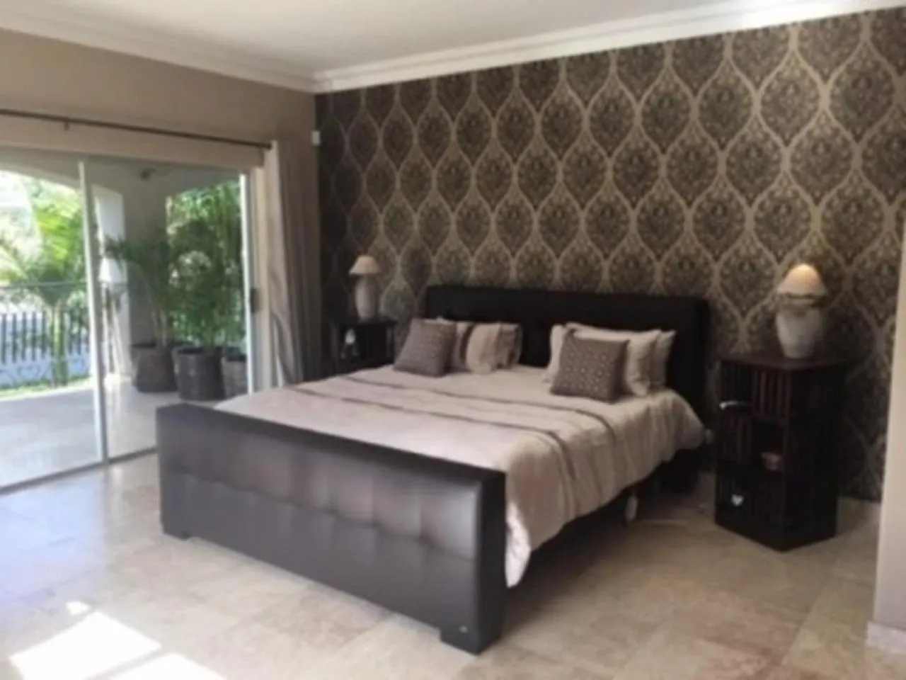 Bedroom in African Palm Cottage and Guesthouse