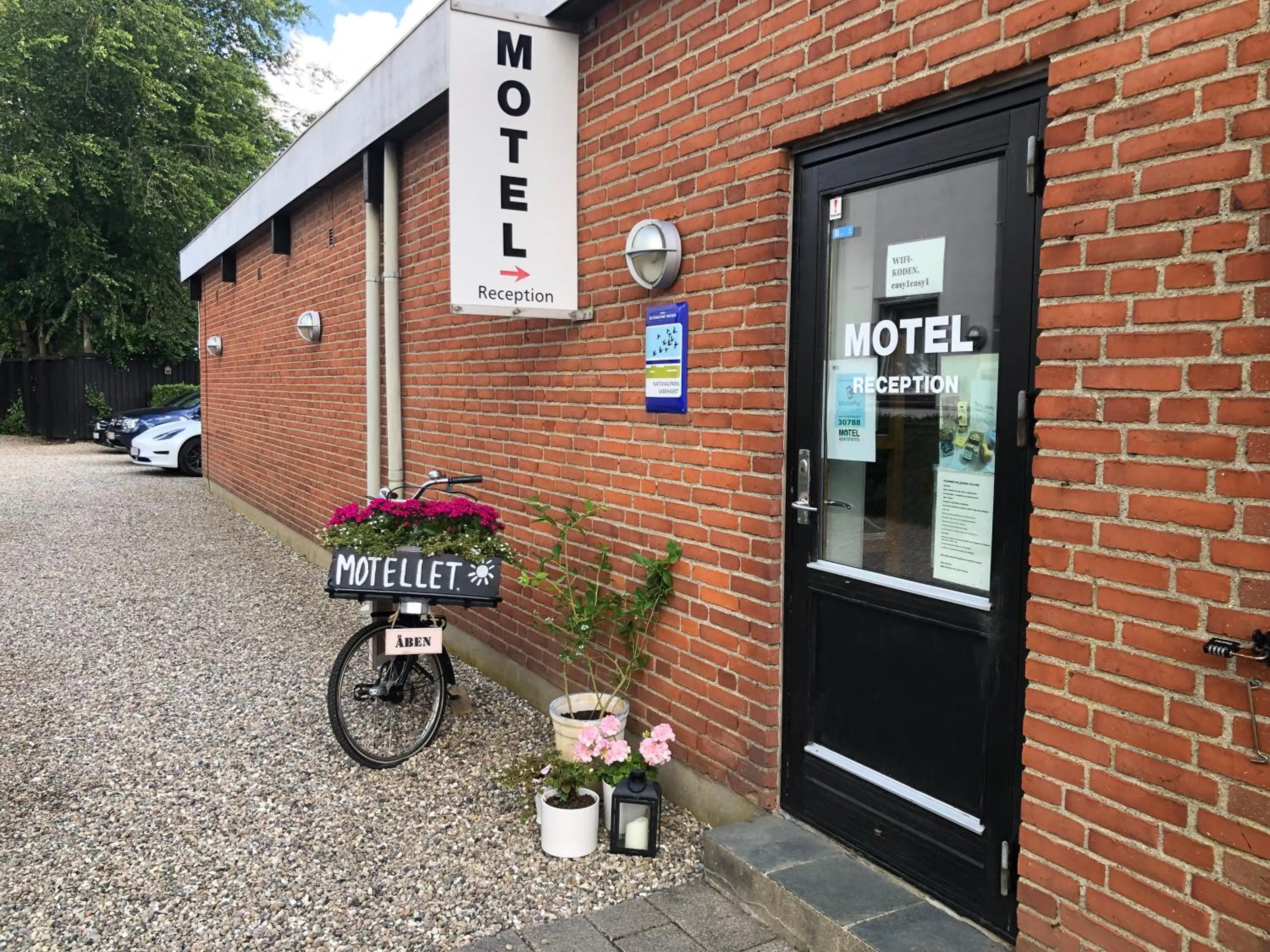 Property logo or sign in Motel Apartments