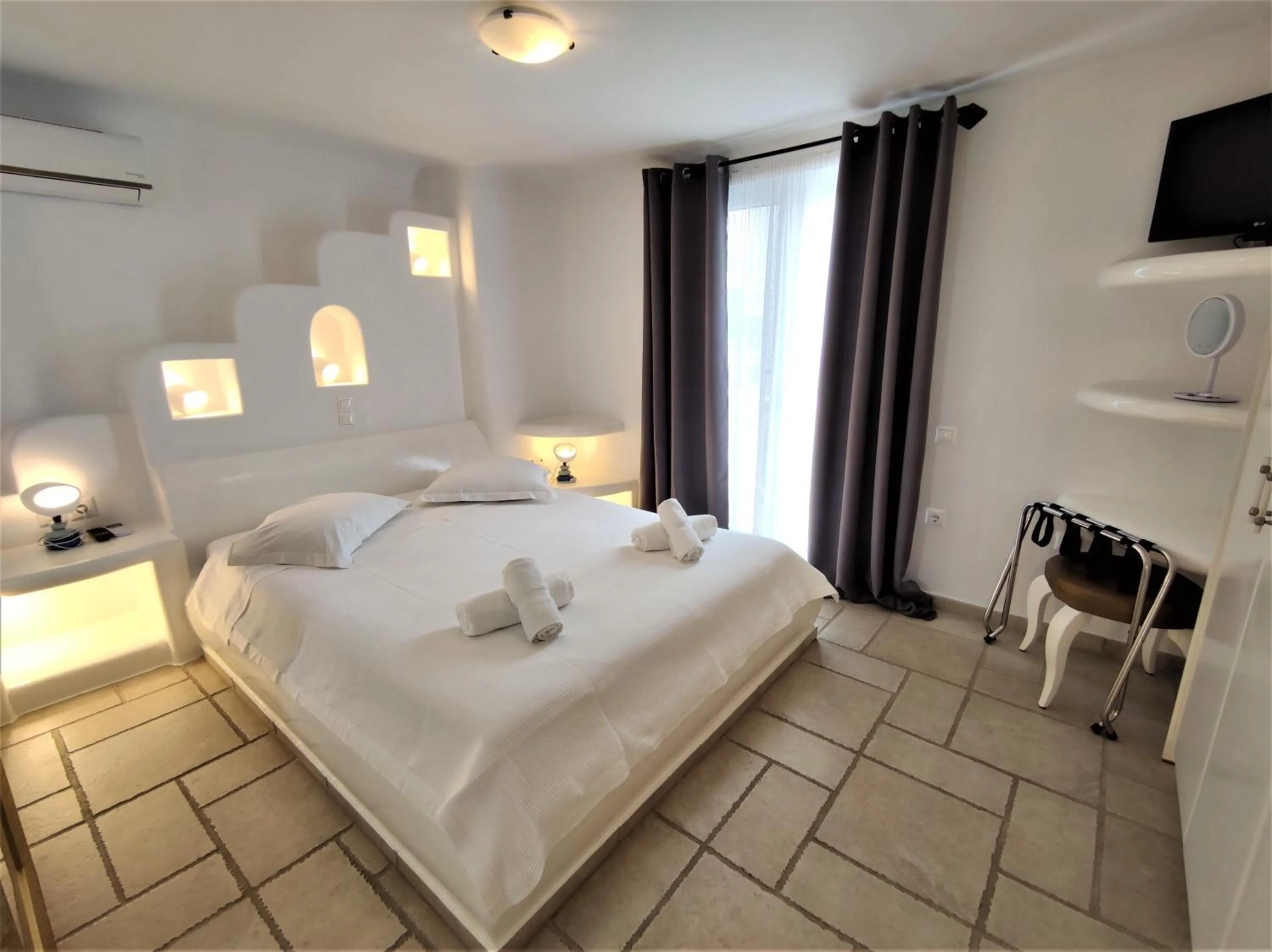 Bed in Mykonian Iros Suites & Villas