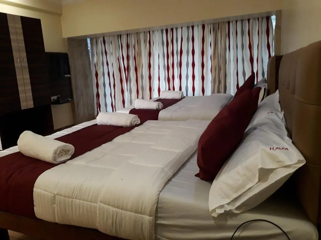Photo of the whole room, Bed in Hotel Alfa International Near Nanavati Hospital Mumbai Near Airport Mumbai Near Juhu Beach