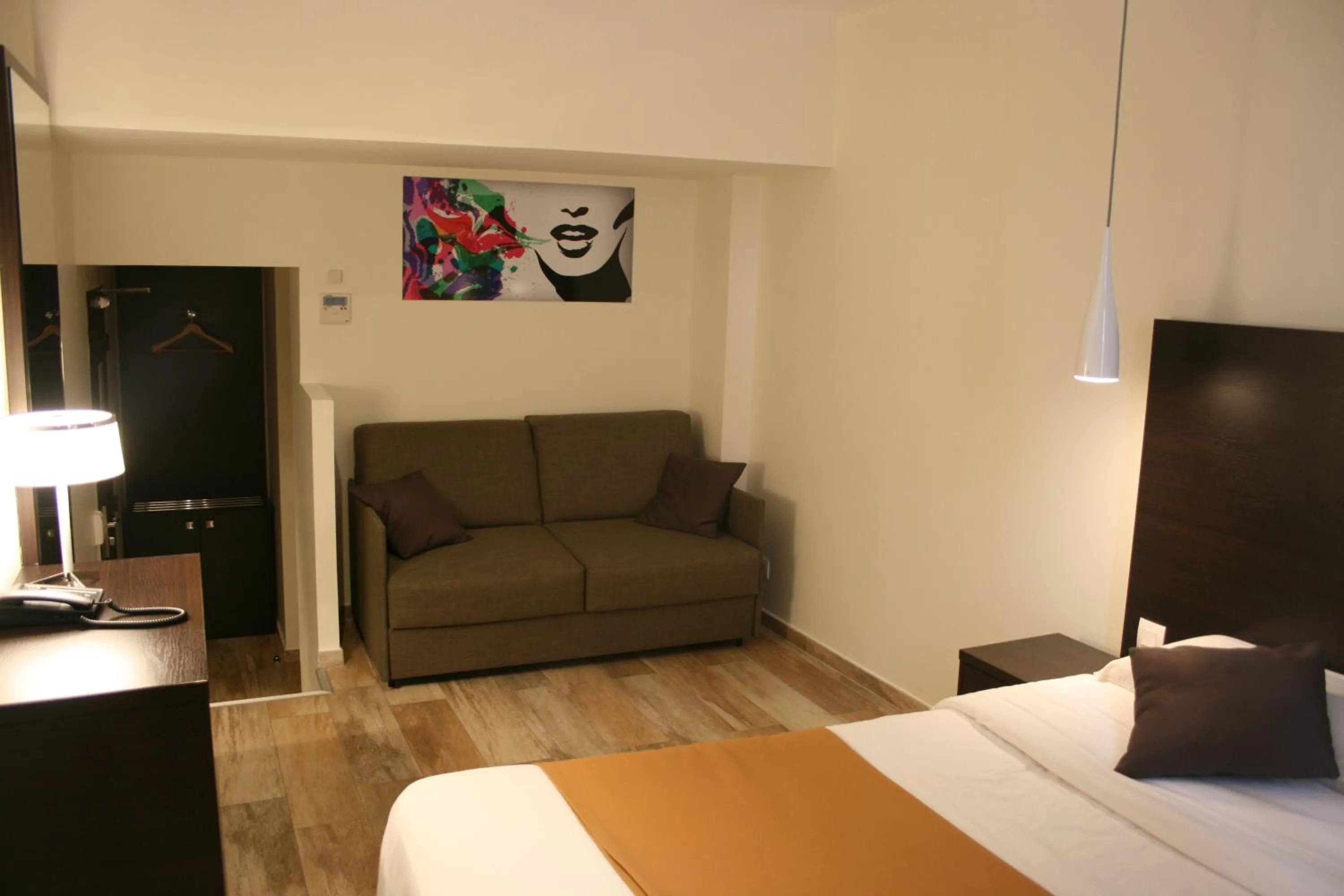 Seating area, Bed in Central Hotel