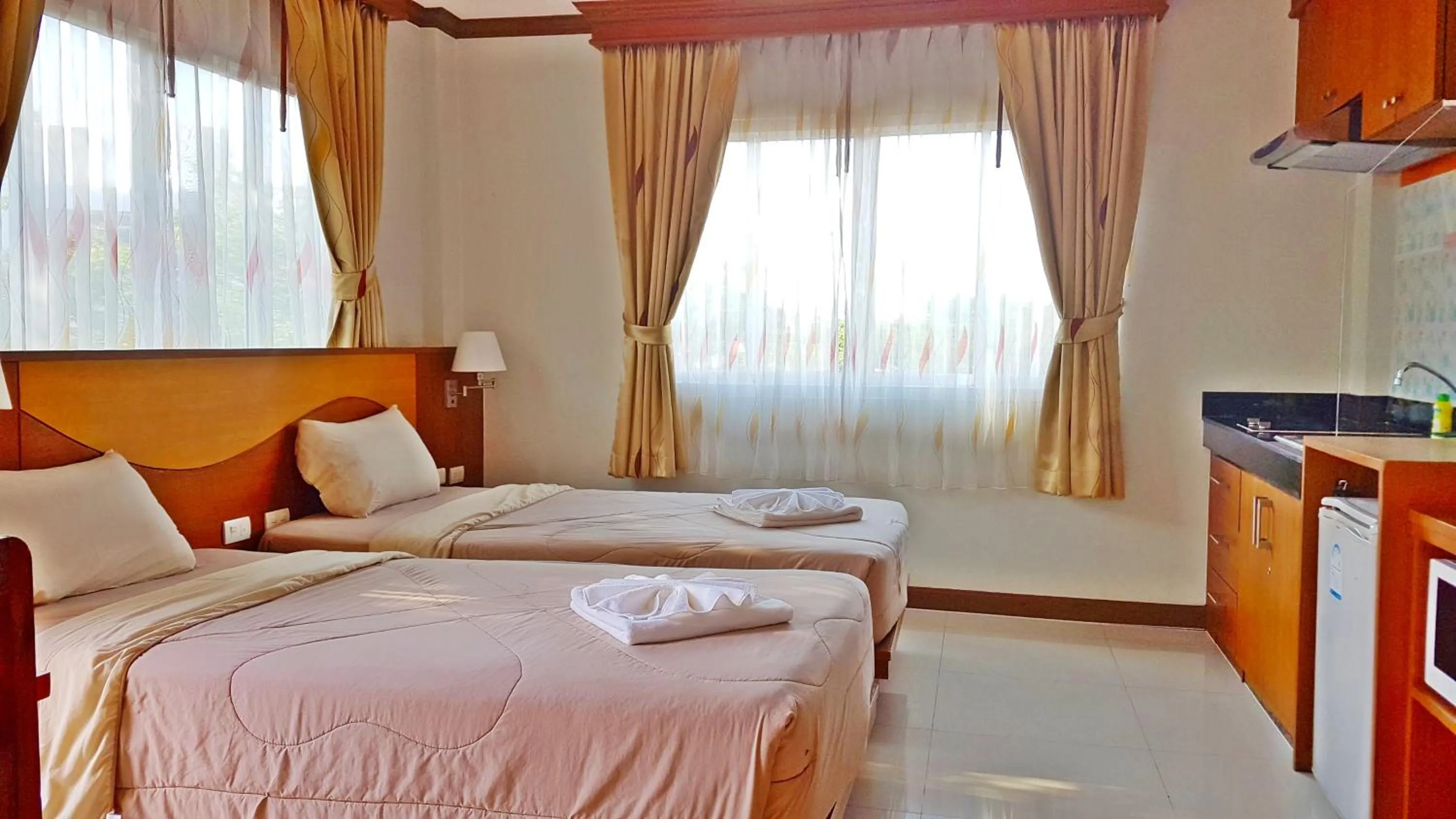 Bed in Green Harbor Hotel & Service Apartment