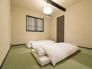 Bed in MUSUBI HOTEL MACHIYA Haruyoshi