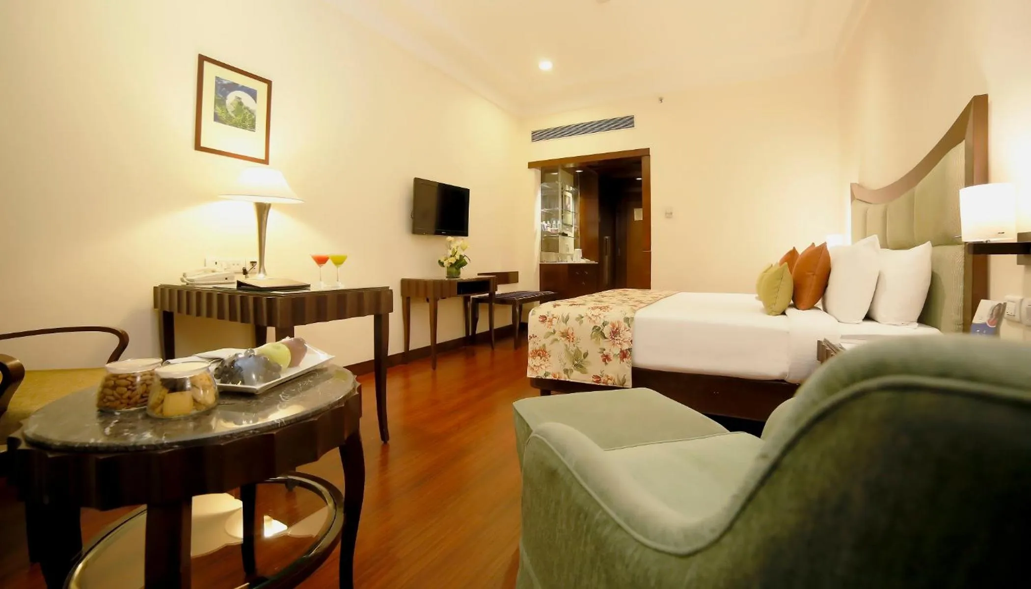 Seating area, Bed in Muse Sarovar Portico Nehru Place