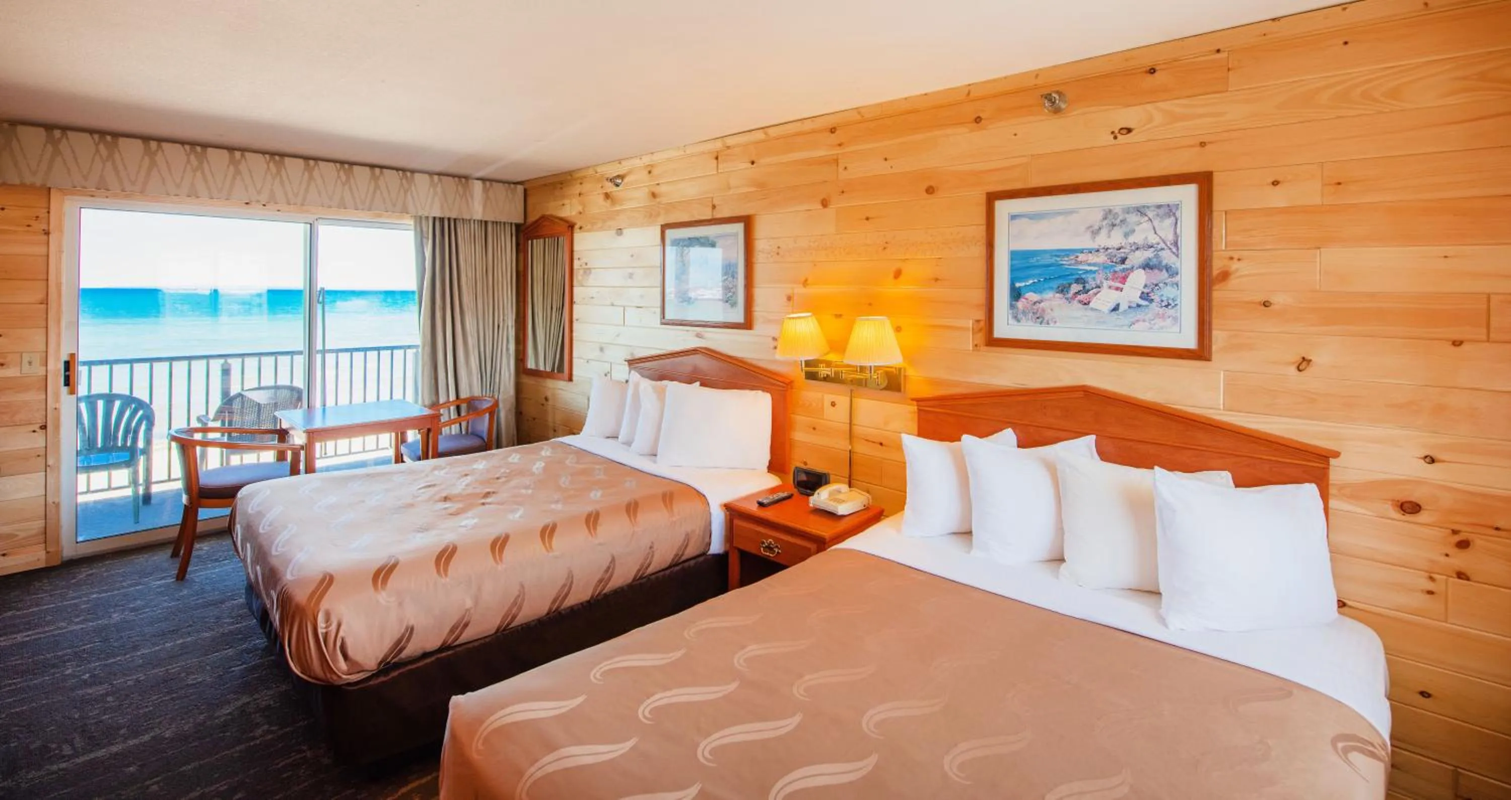 Bed in Quality Inn & Suites Mackinaw City Beachfront