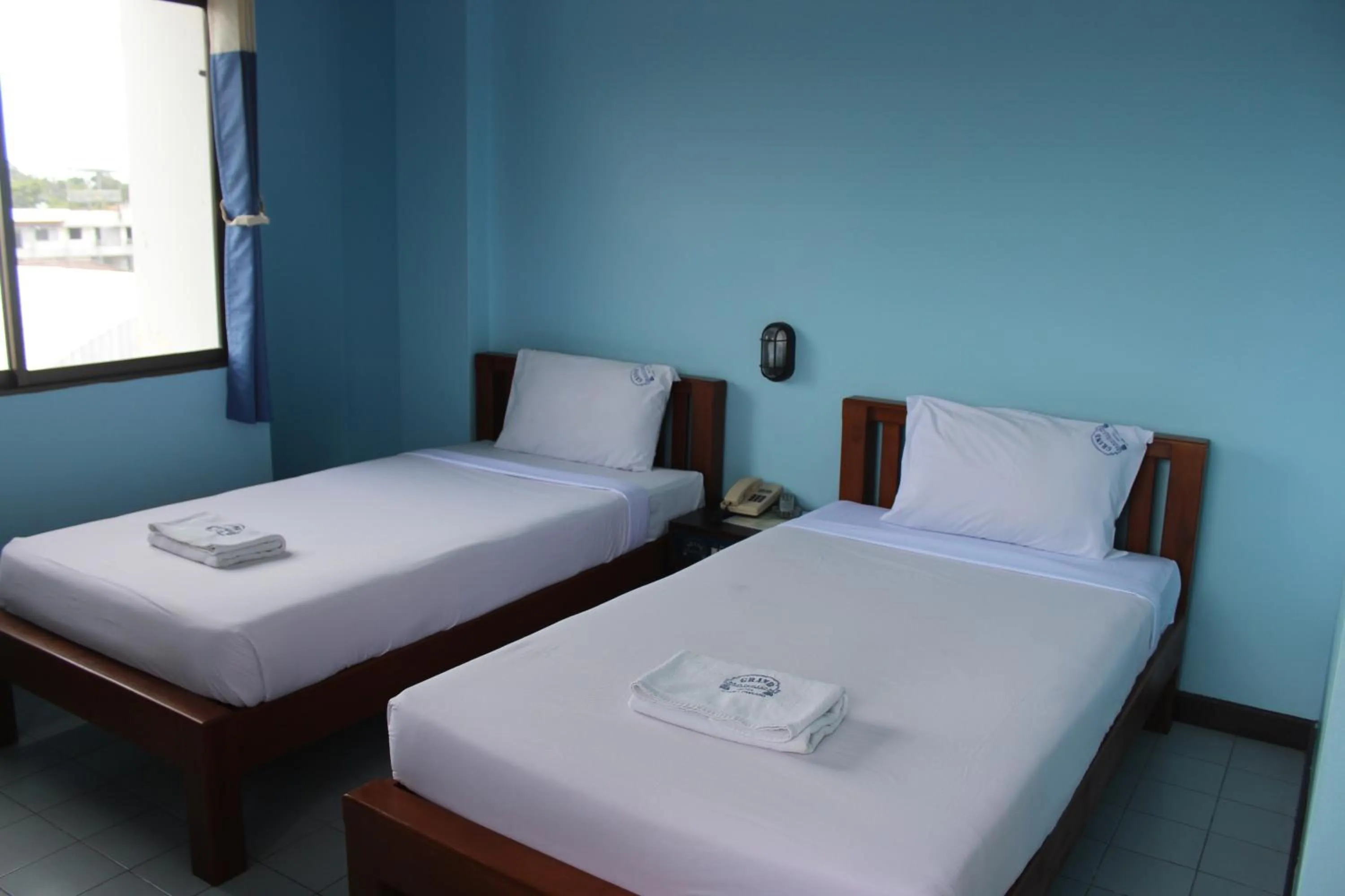 Bed in Grand Mansion Hotel