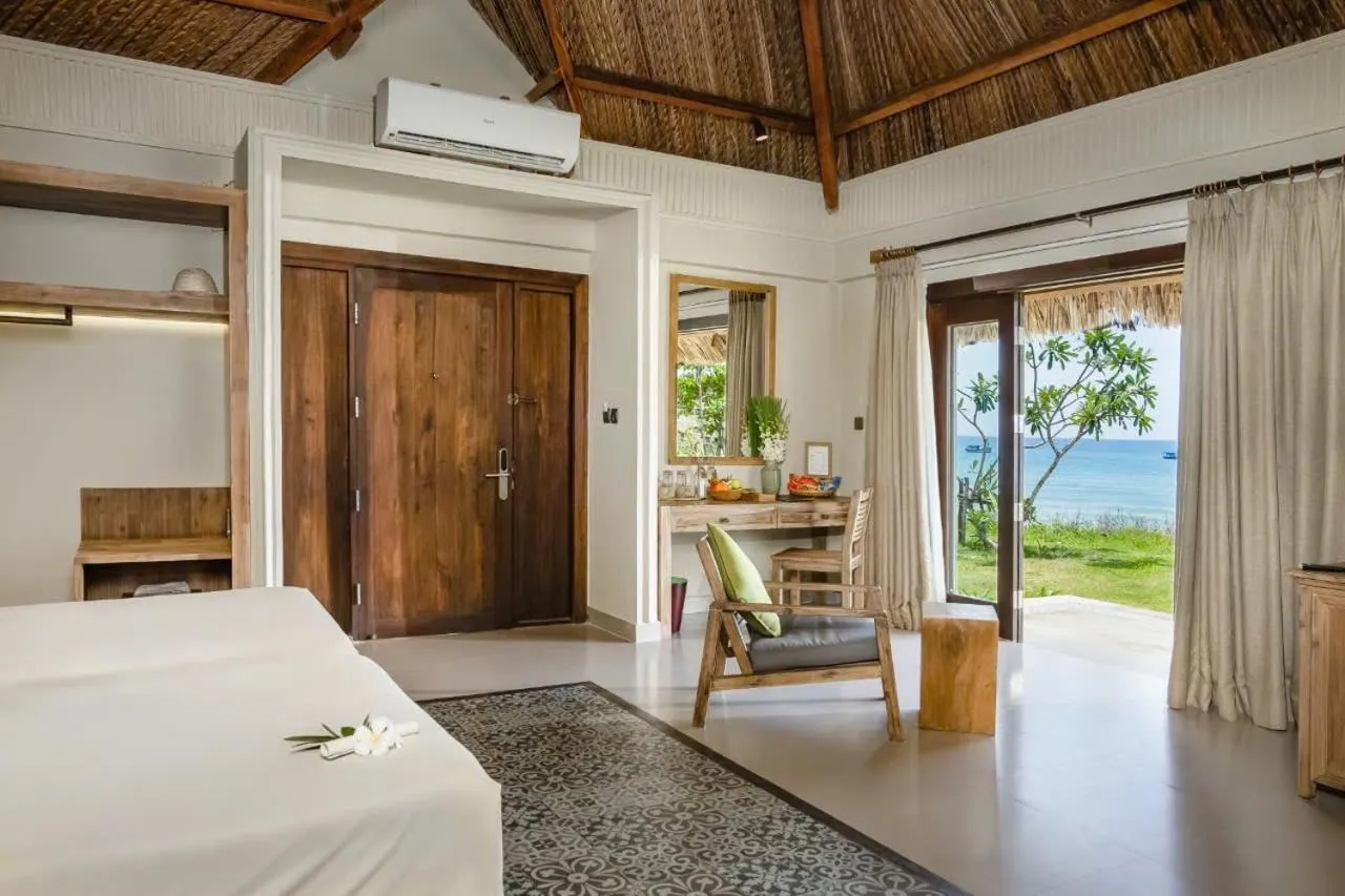 Living room, Bed in Crown Retreat Quy Nhon Resort