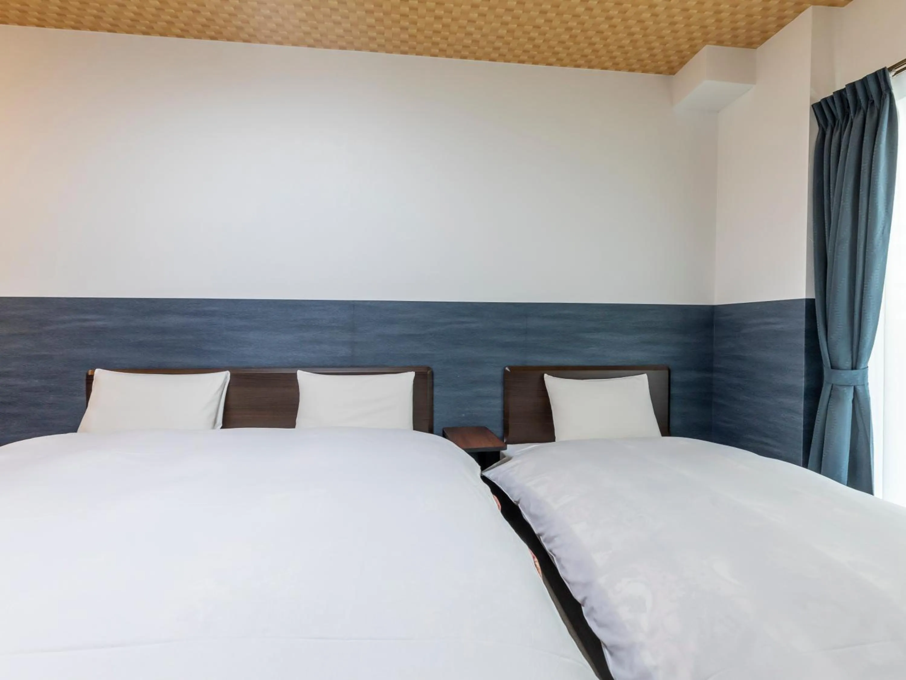 Bed in Tabist Kyogura Kyoto Nijo