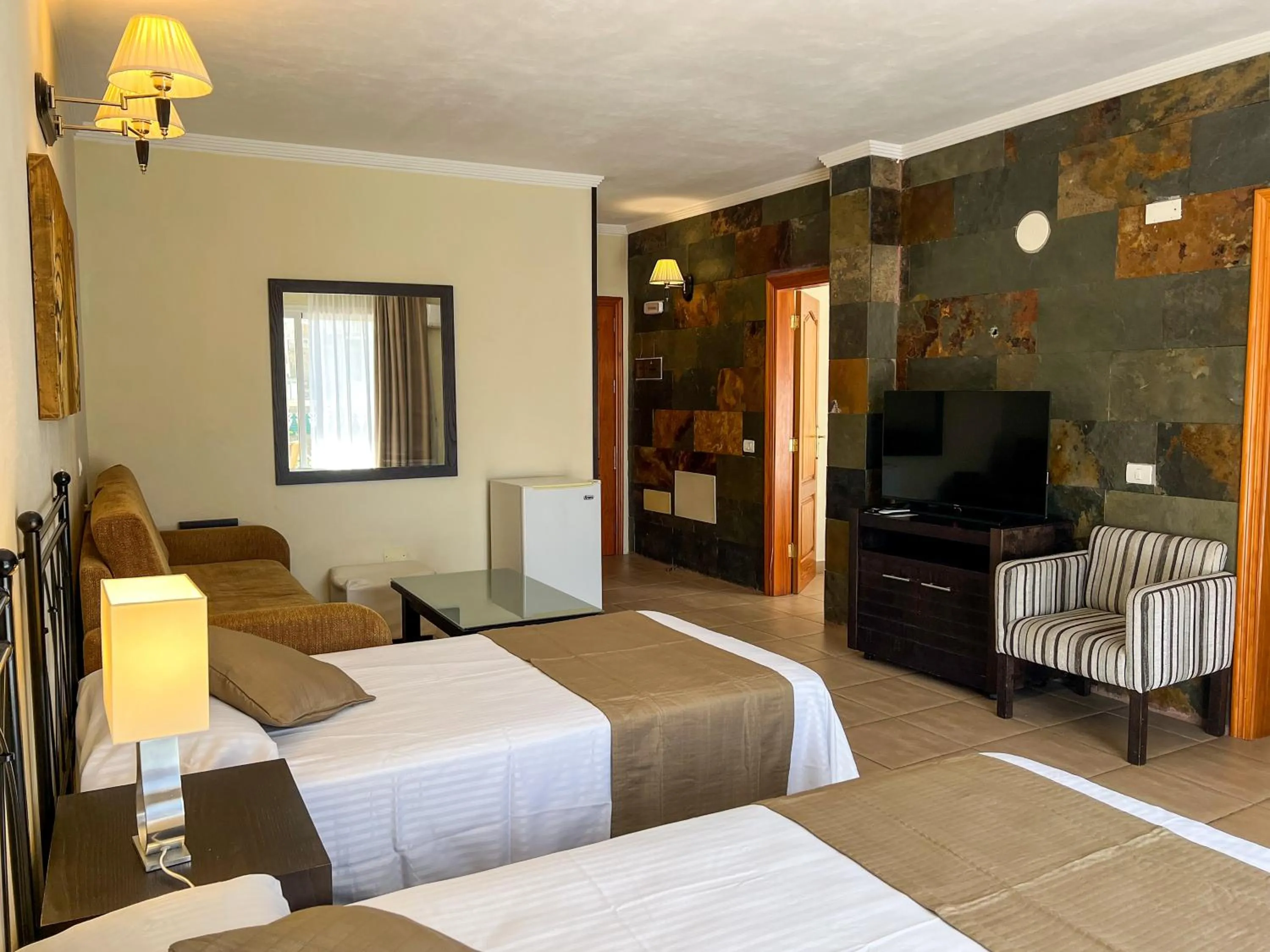 Bed in Hotel La Aldea Suites