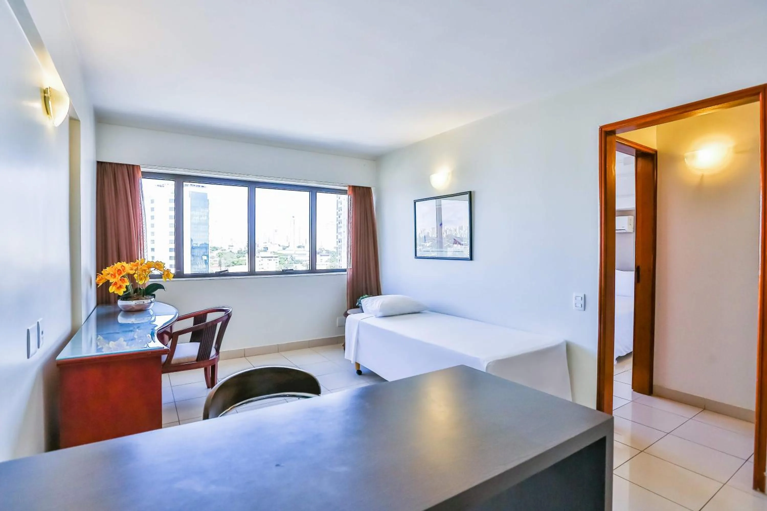 Seating area, Bed in Golden Tulip Goiania Address