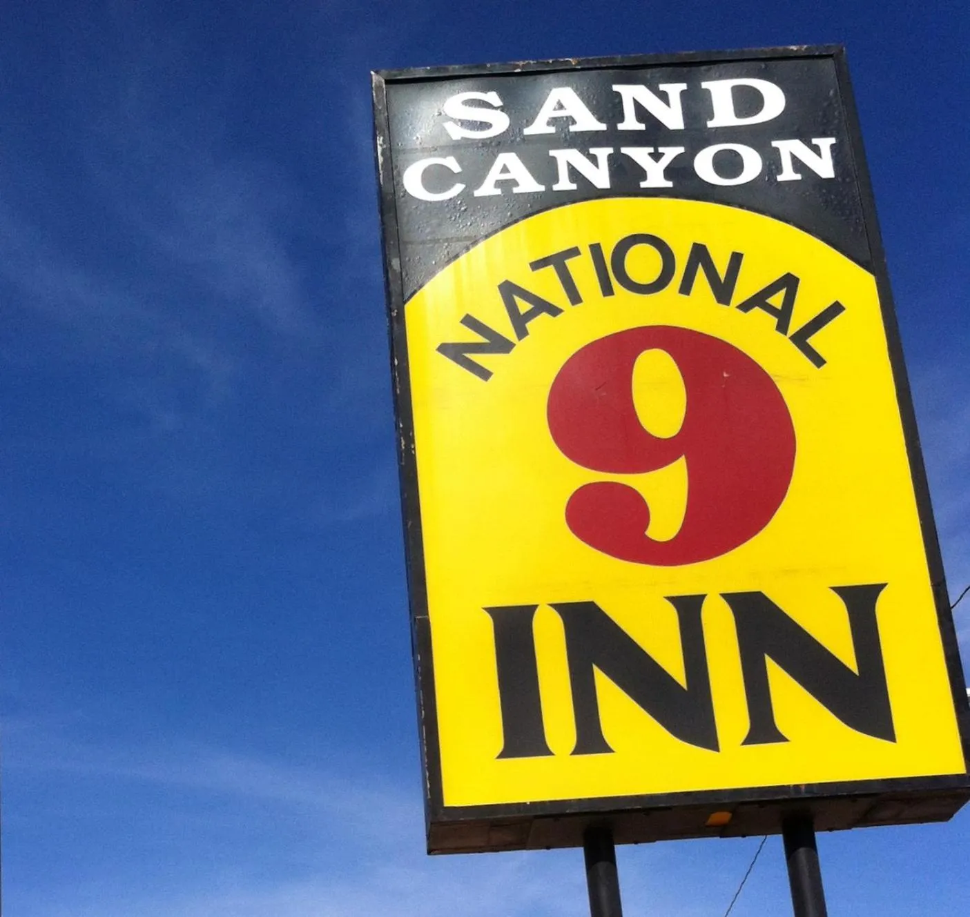 Property logo or sign in National 9 Inn Sand Canyon
