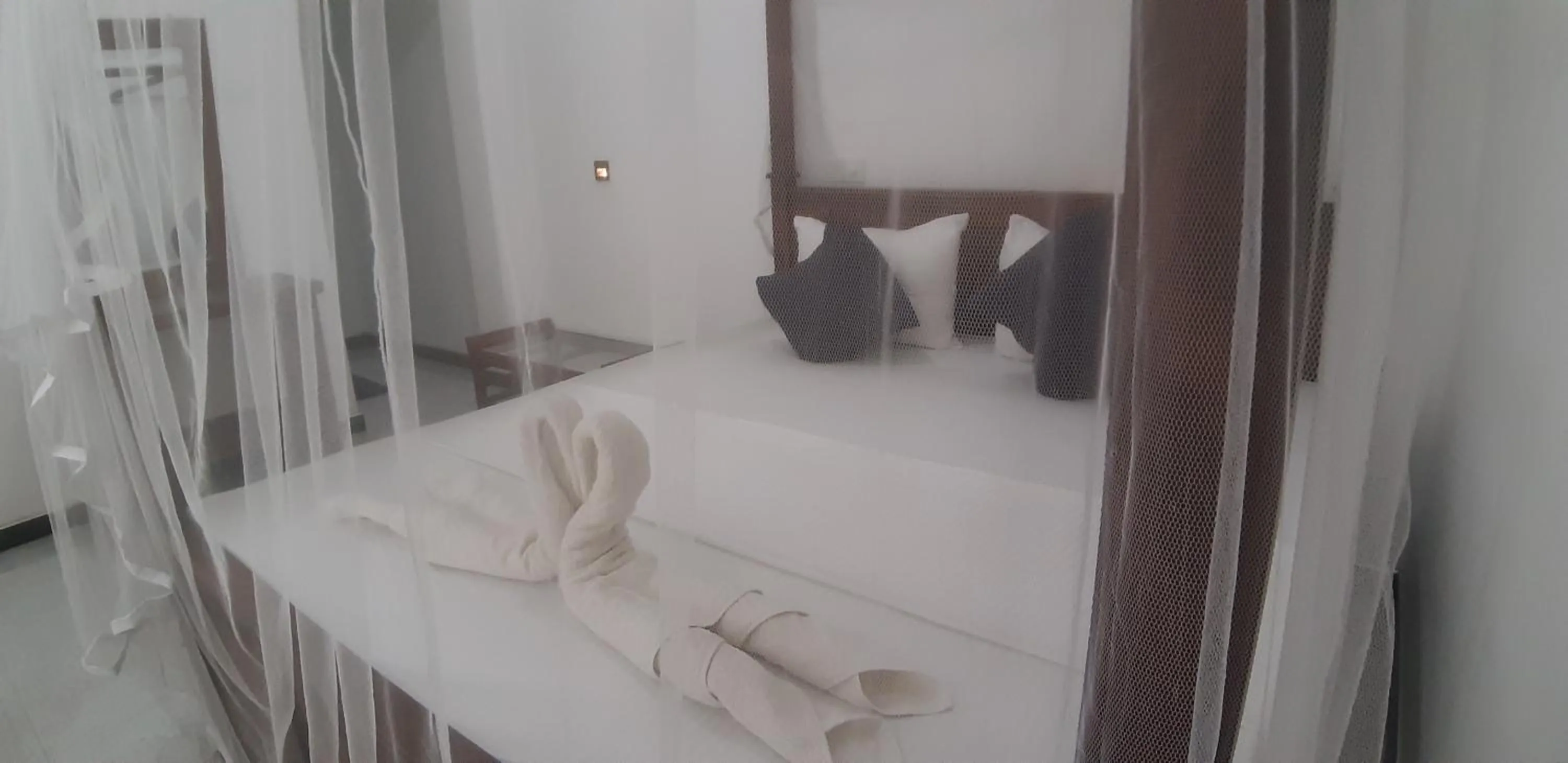 Bed in Butterfly Homestead Hotel