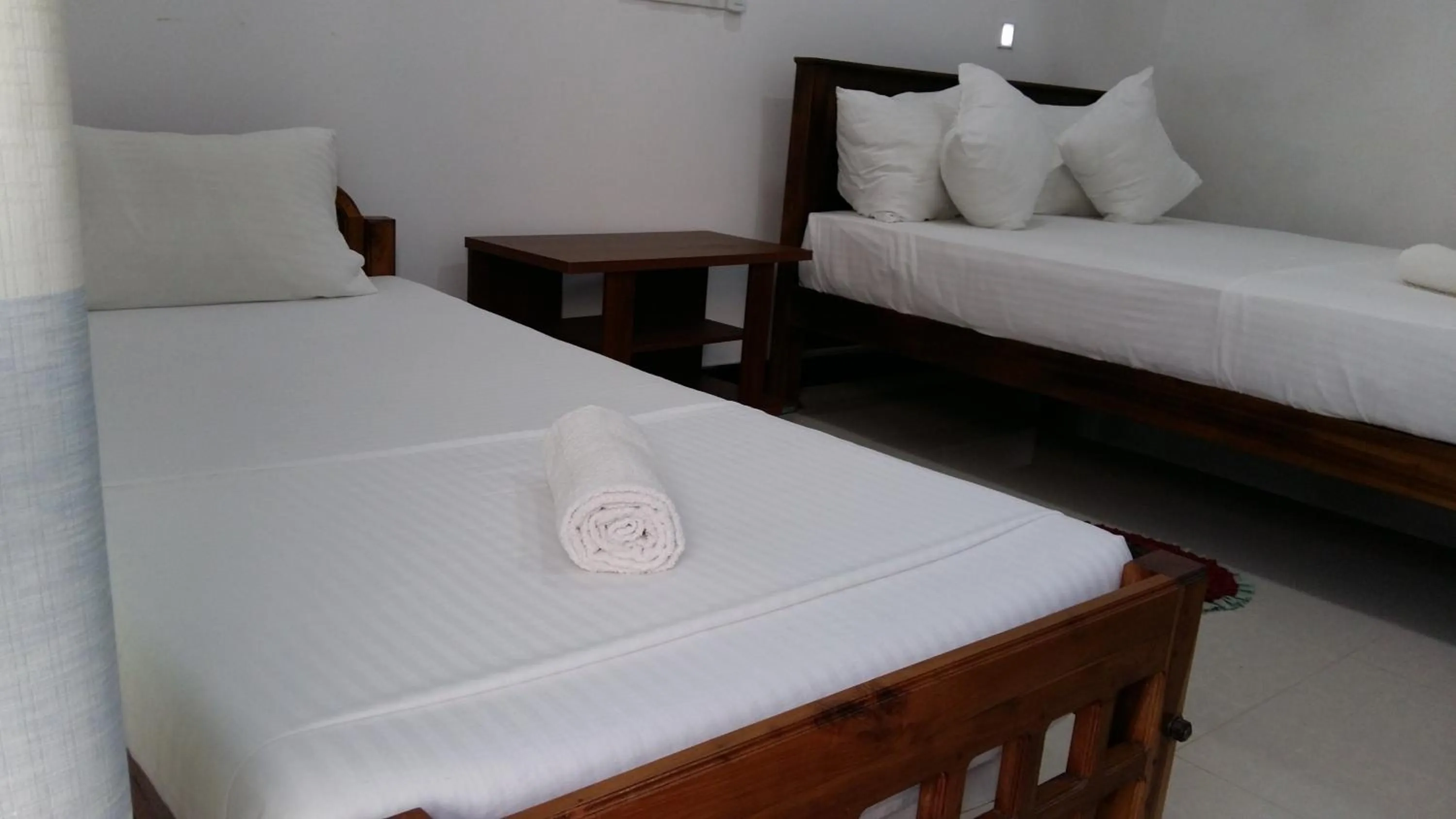 Bed in Butterfly Homestead Hotel