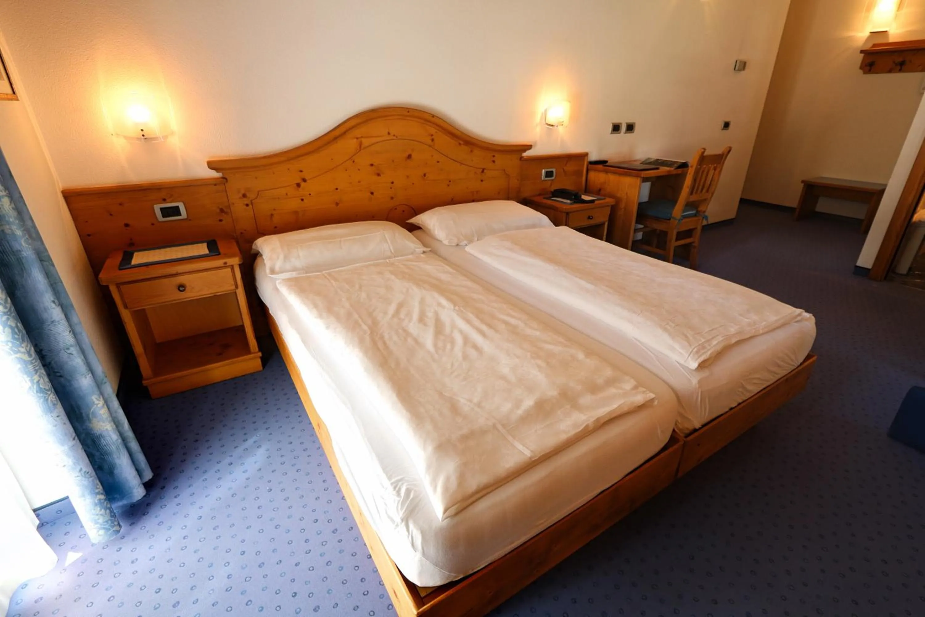Bed in Hotel Garni Sottobosco