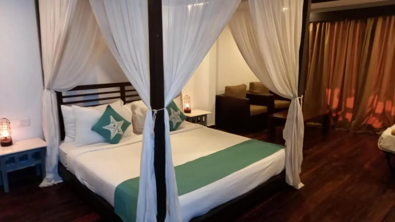 Seating area, Bed in SinQ Beach Morjim