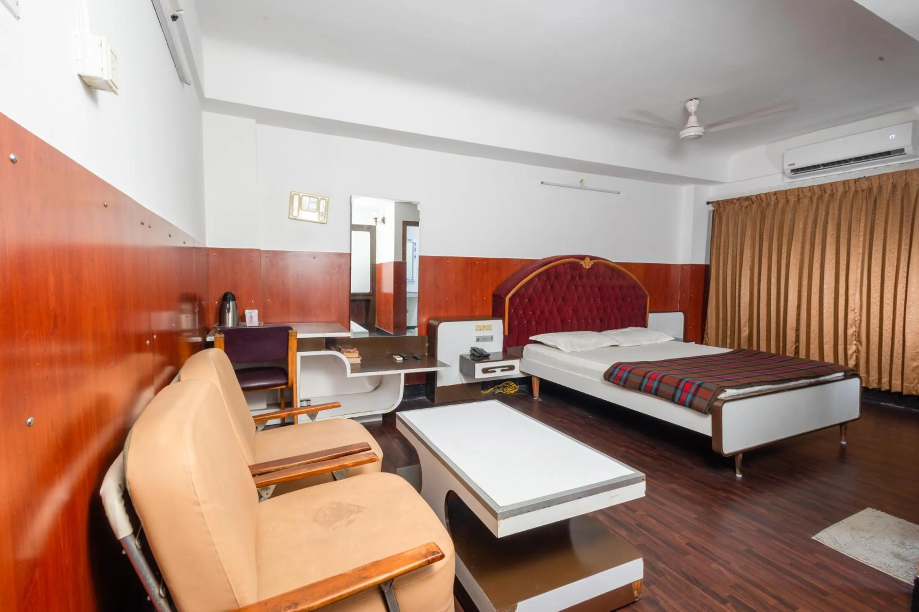 Seating area, Bed in Hotel Srilakshmi