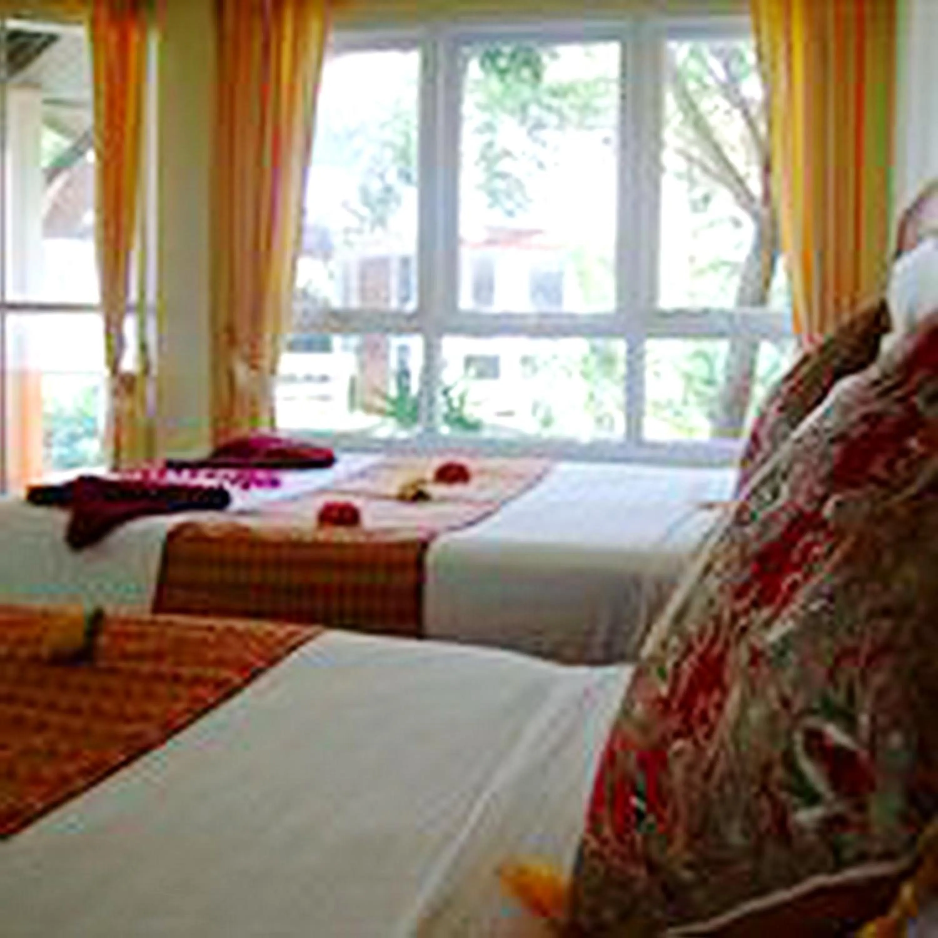 Bed in Lanta Palm Beach Resort , Beach Bungalow - Koh Lanta