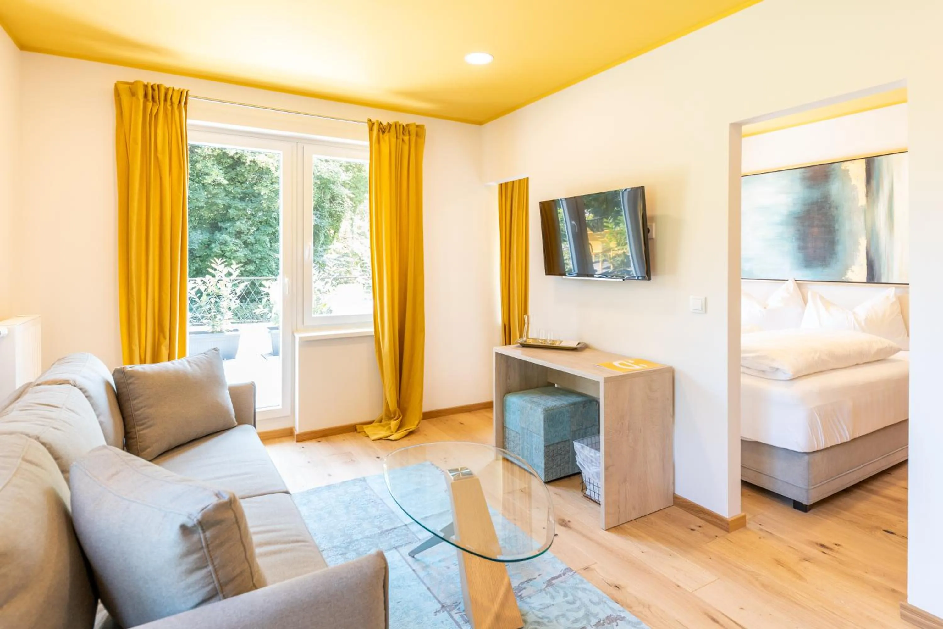 Seating area, Bed in Boutiquehotel Caravella Velden by S4Y