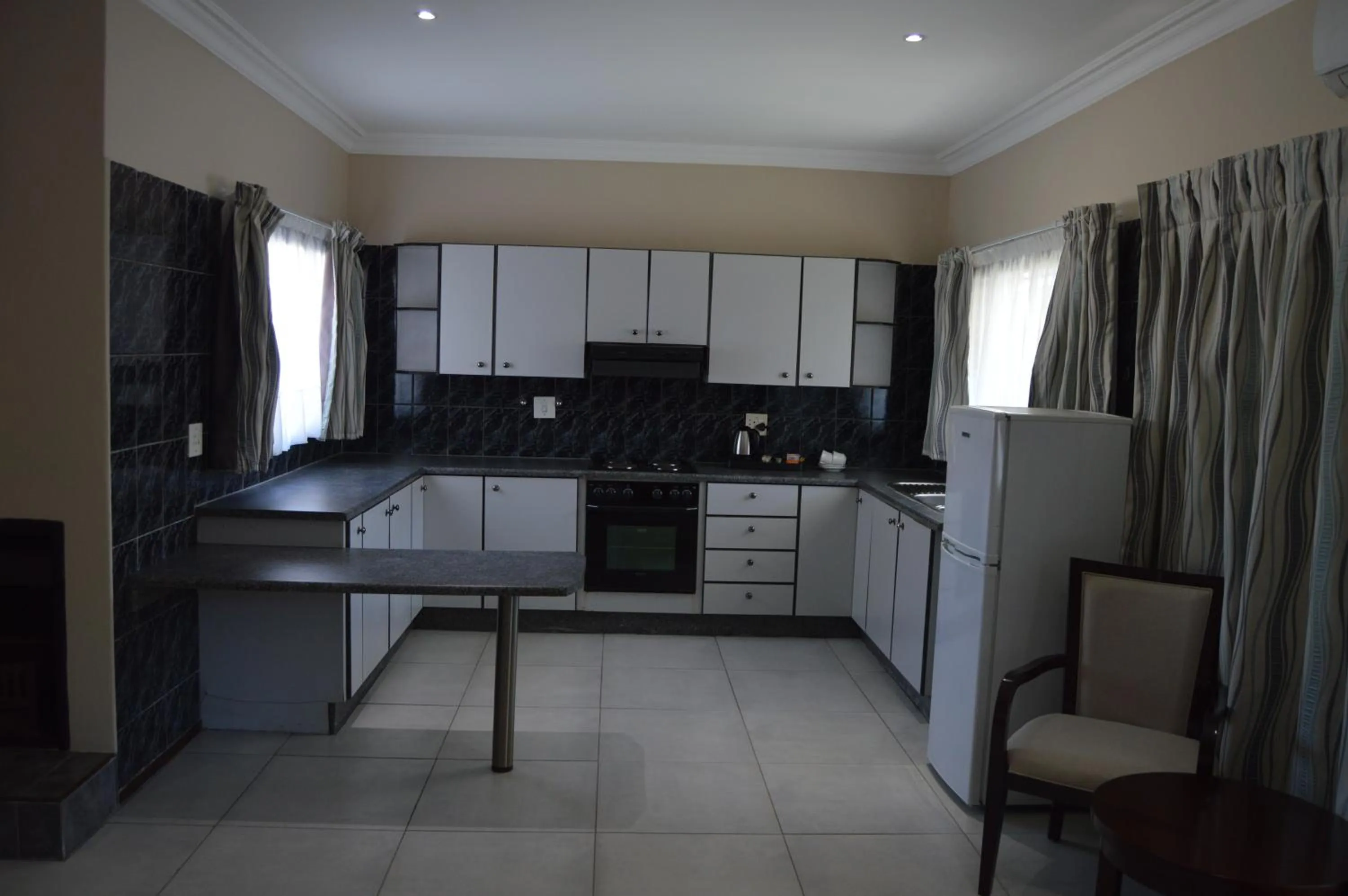 Kitchen or kitchenette in Airport Gardens Boutique Hotel