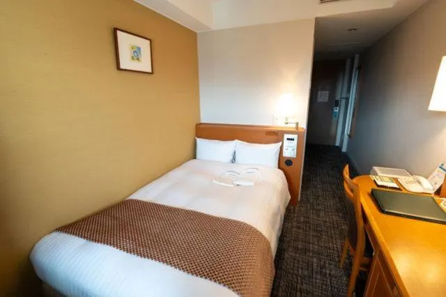 Bed in Toshi Center Hotel