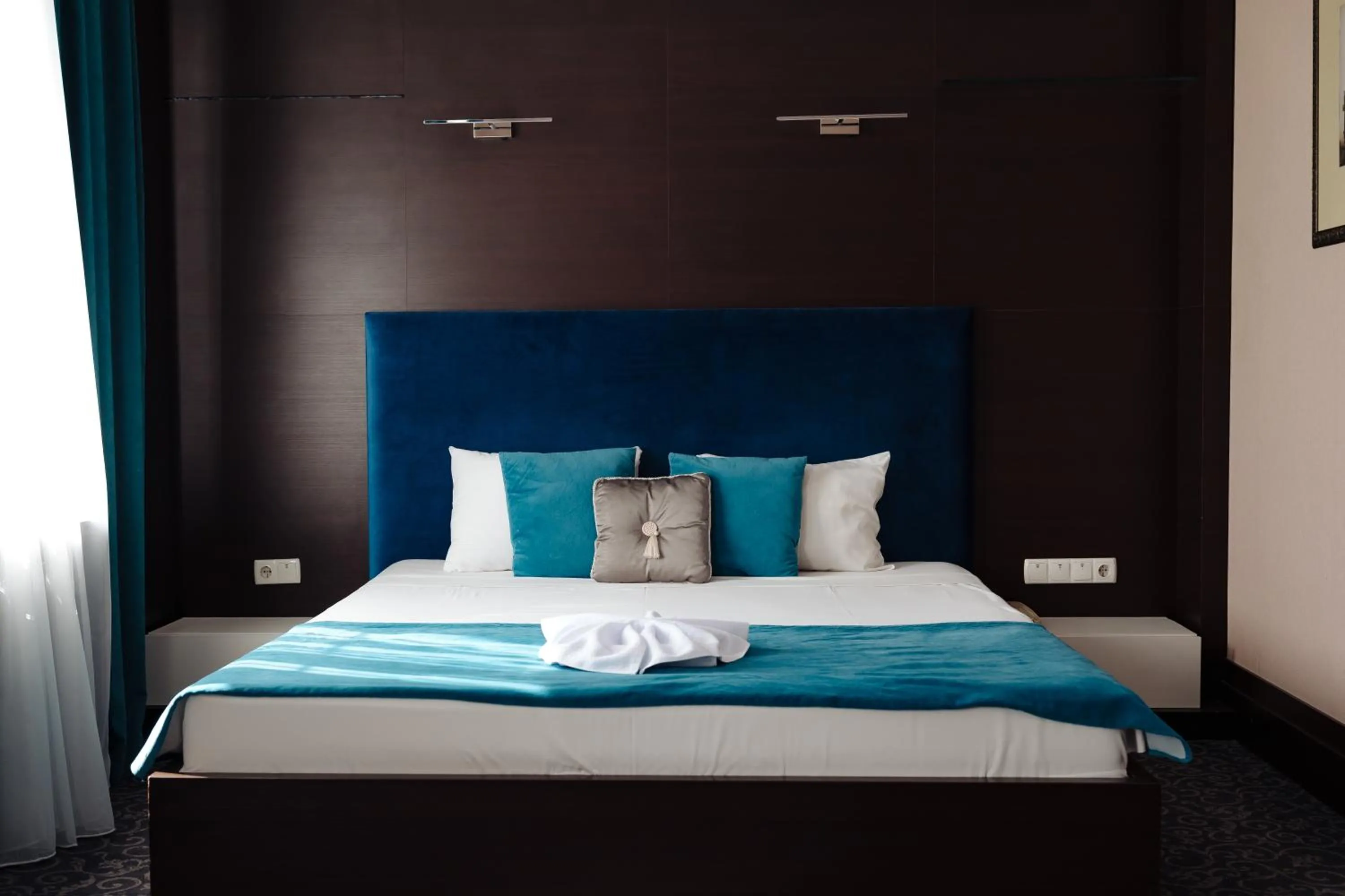 Bed in Maxim Pasha Hotel