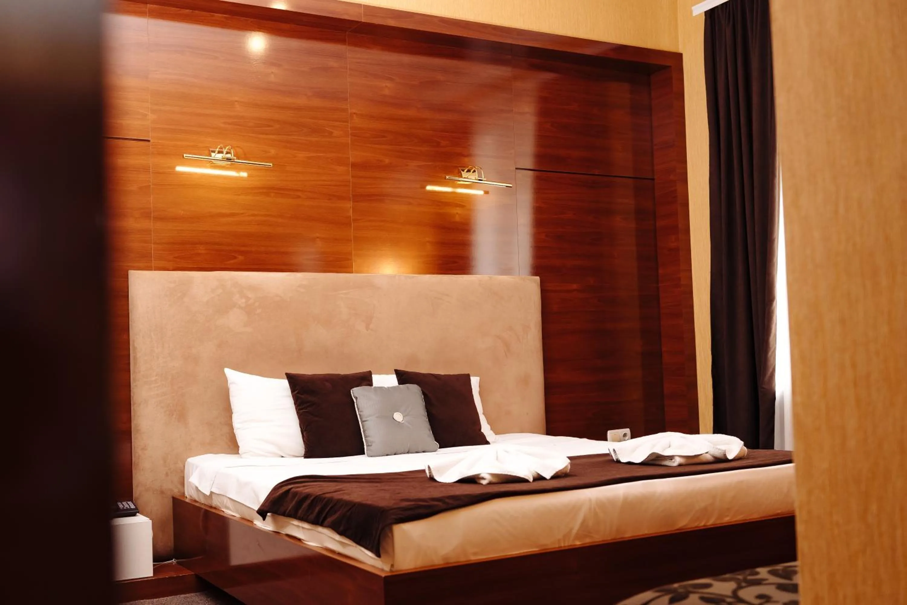 Bed in Maxim Pasha Hotel