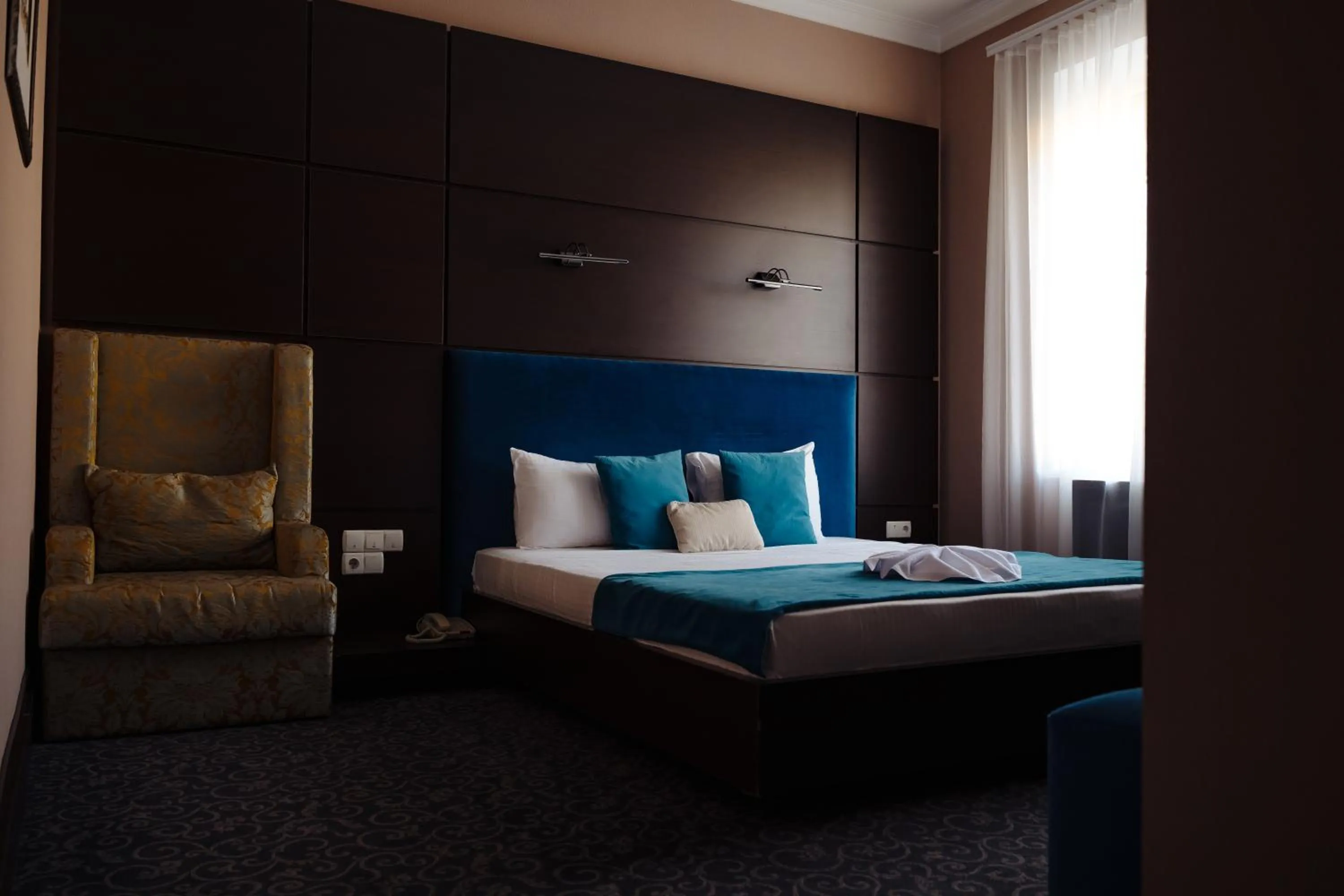 Bed in Maxim Pasha Hotel