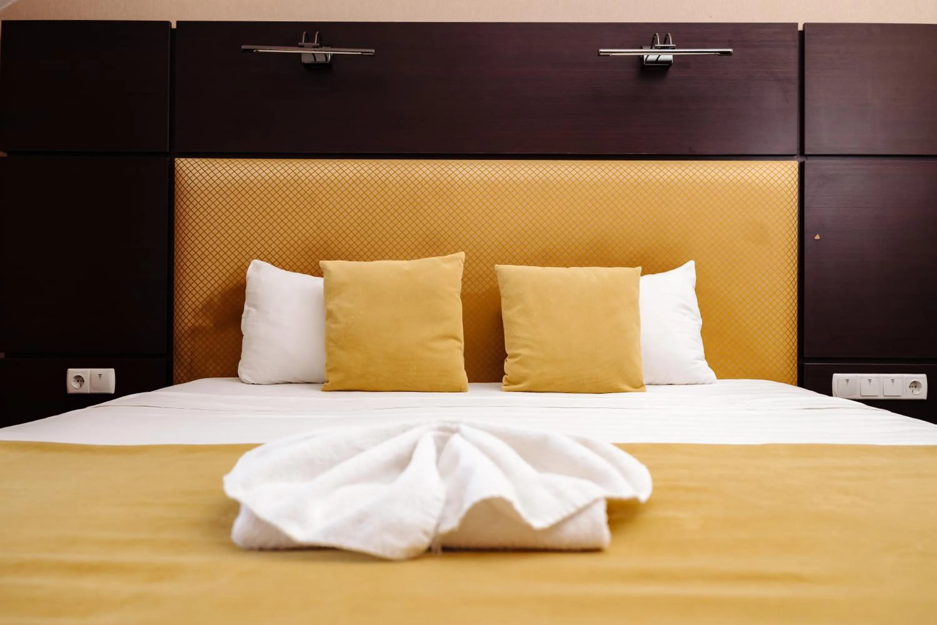 Bed in Maxim Pasha Hotel