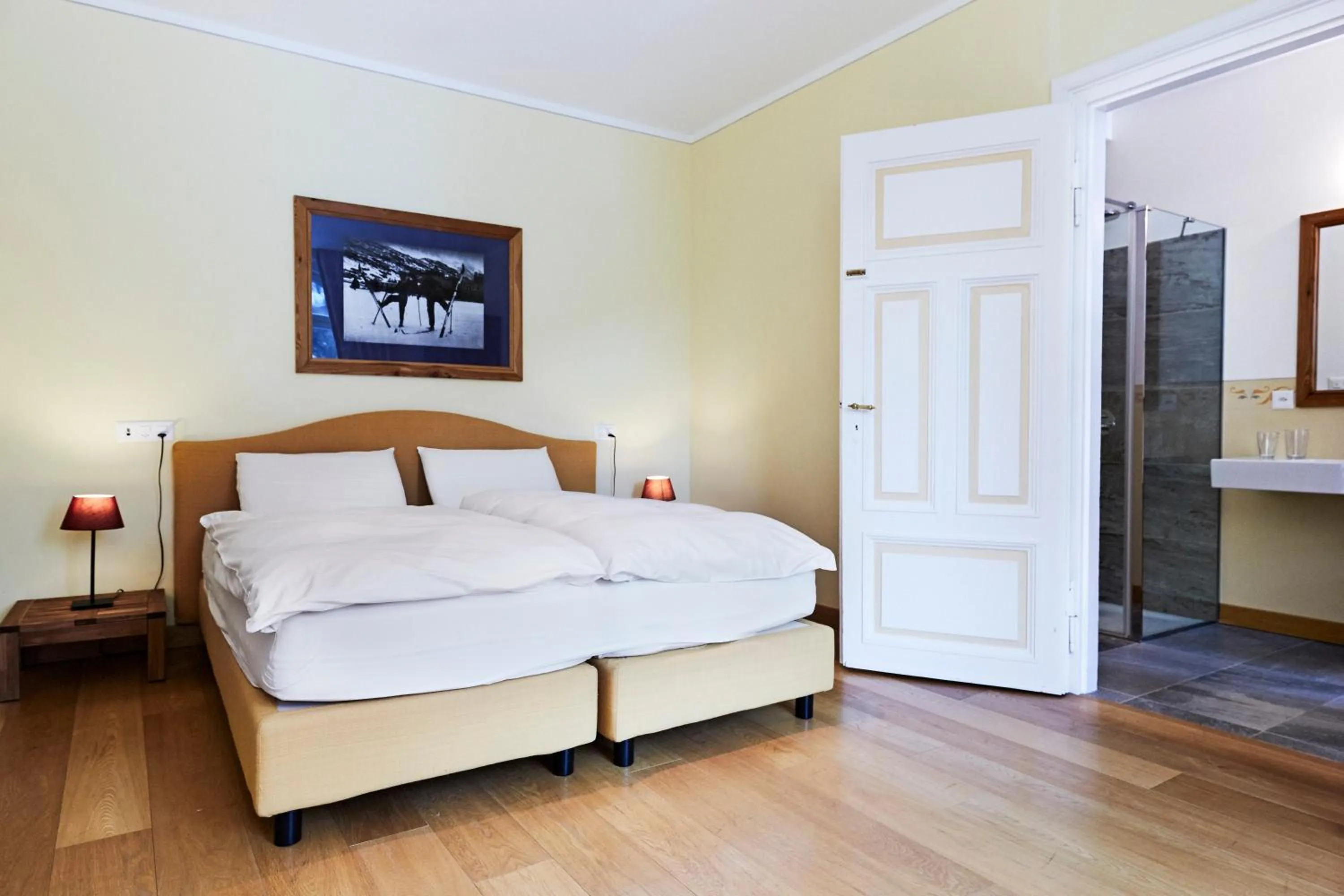 Bed in Maloja Palace Suites CO2-Neutral