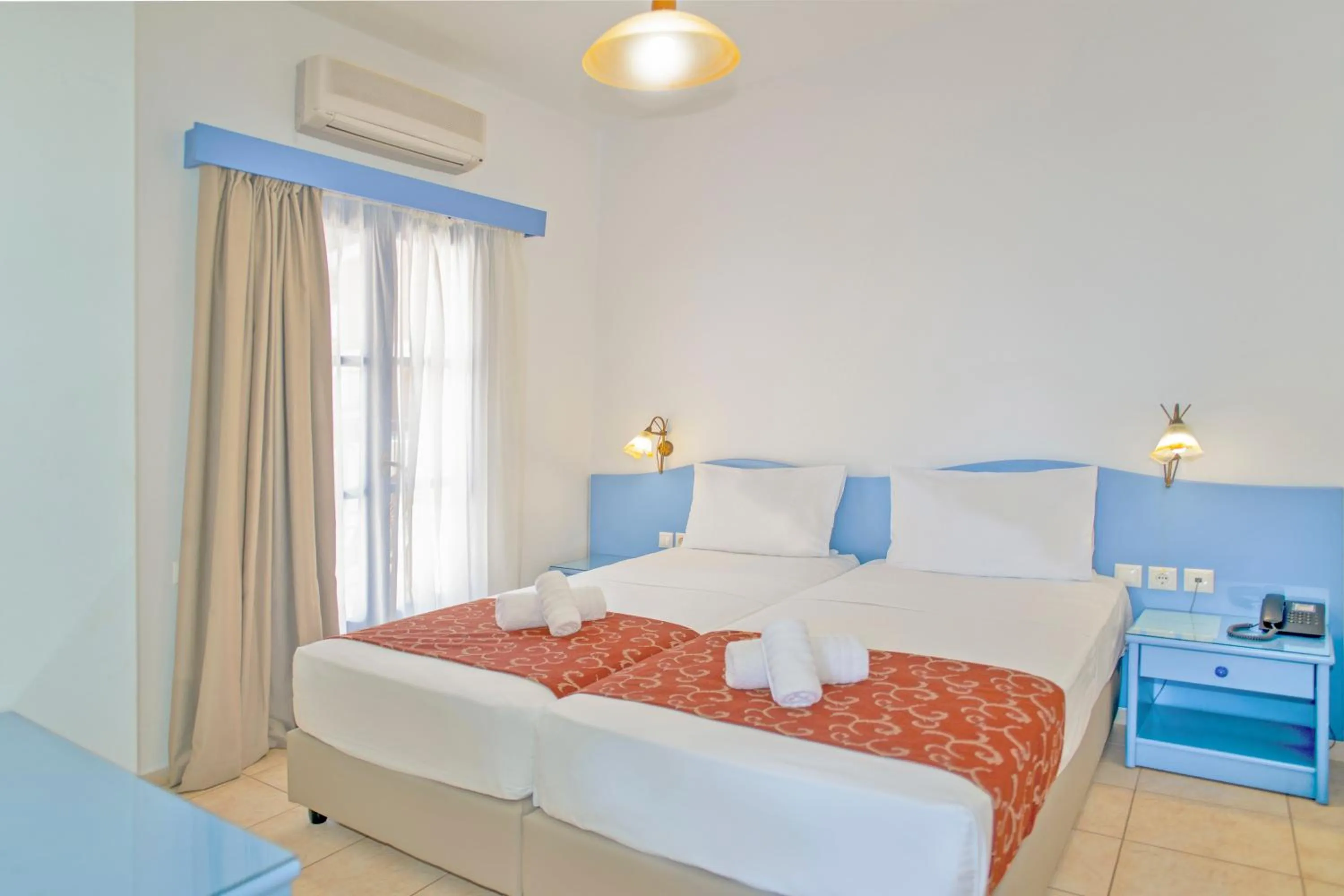 Bed in Astra Village & Suites