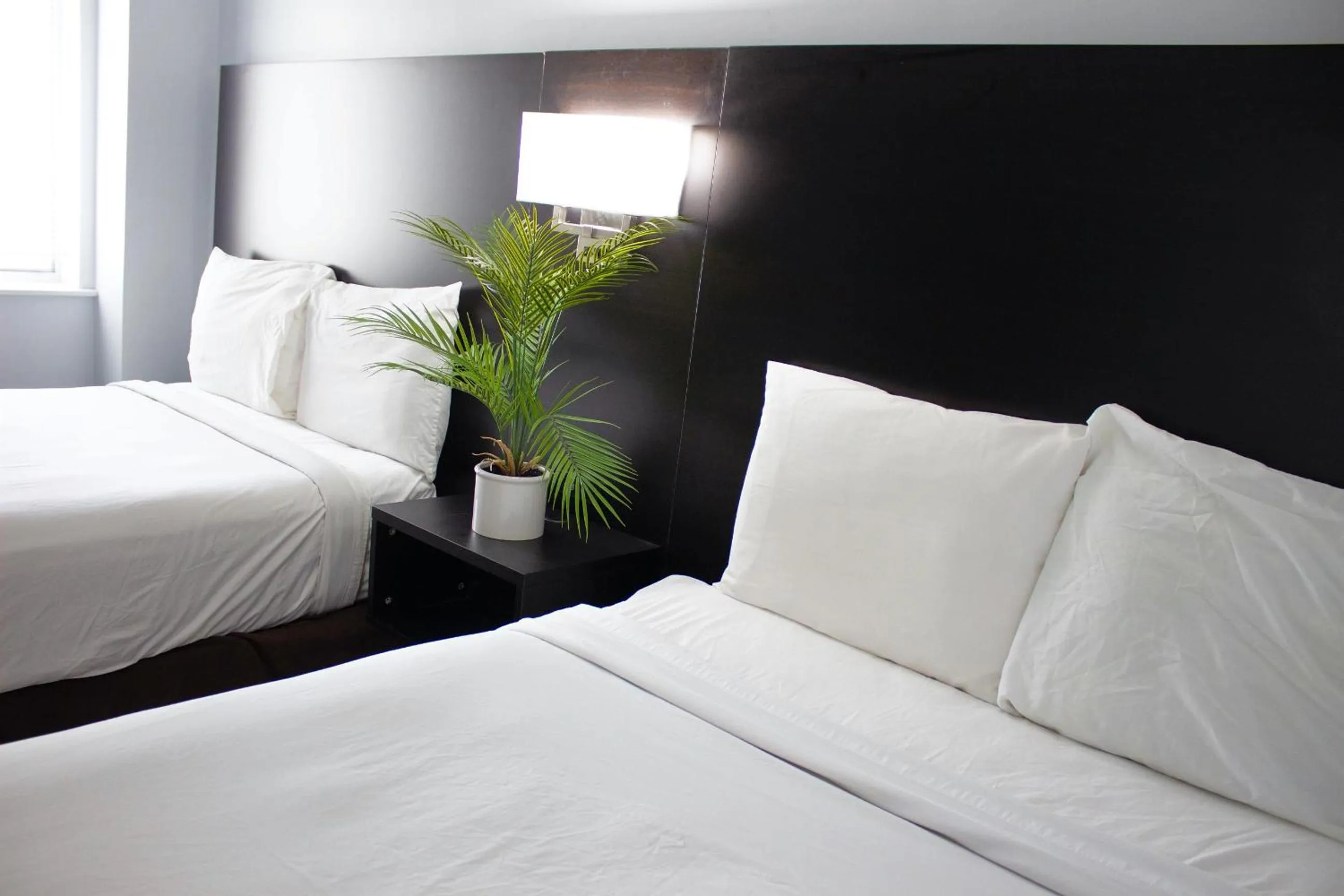 Bed in Sun & Sand Resort Oceanfront Suites