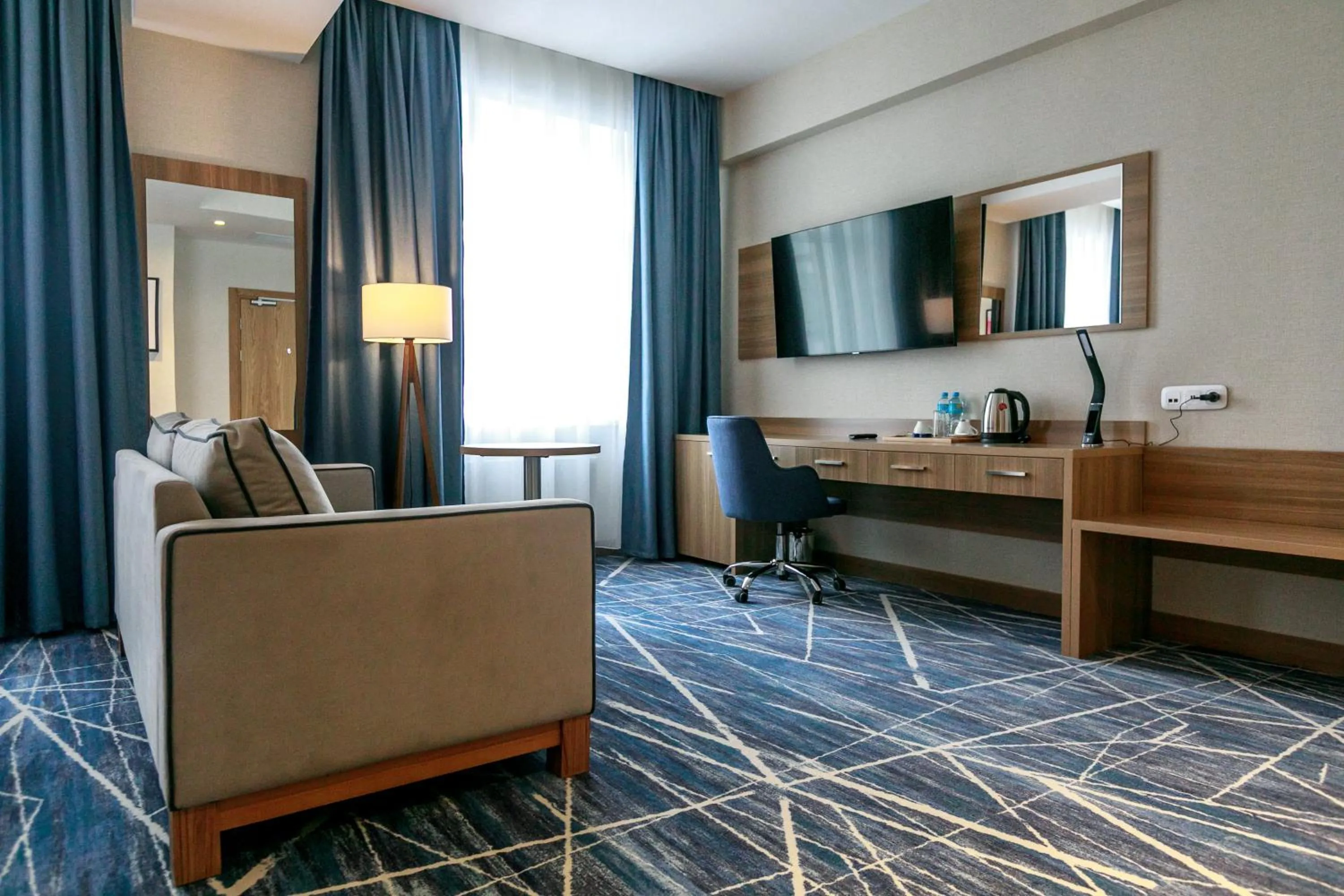 Communal lounge/ TV room in Ramada by Wyndham Astana