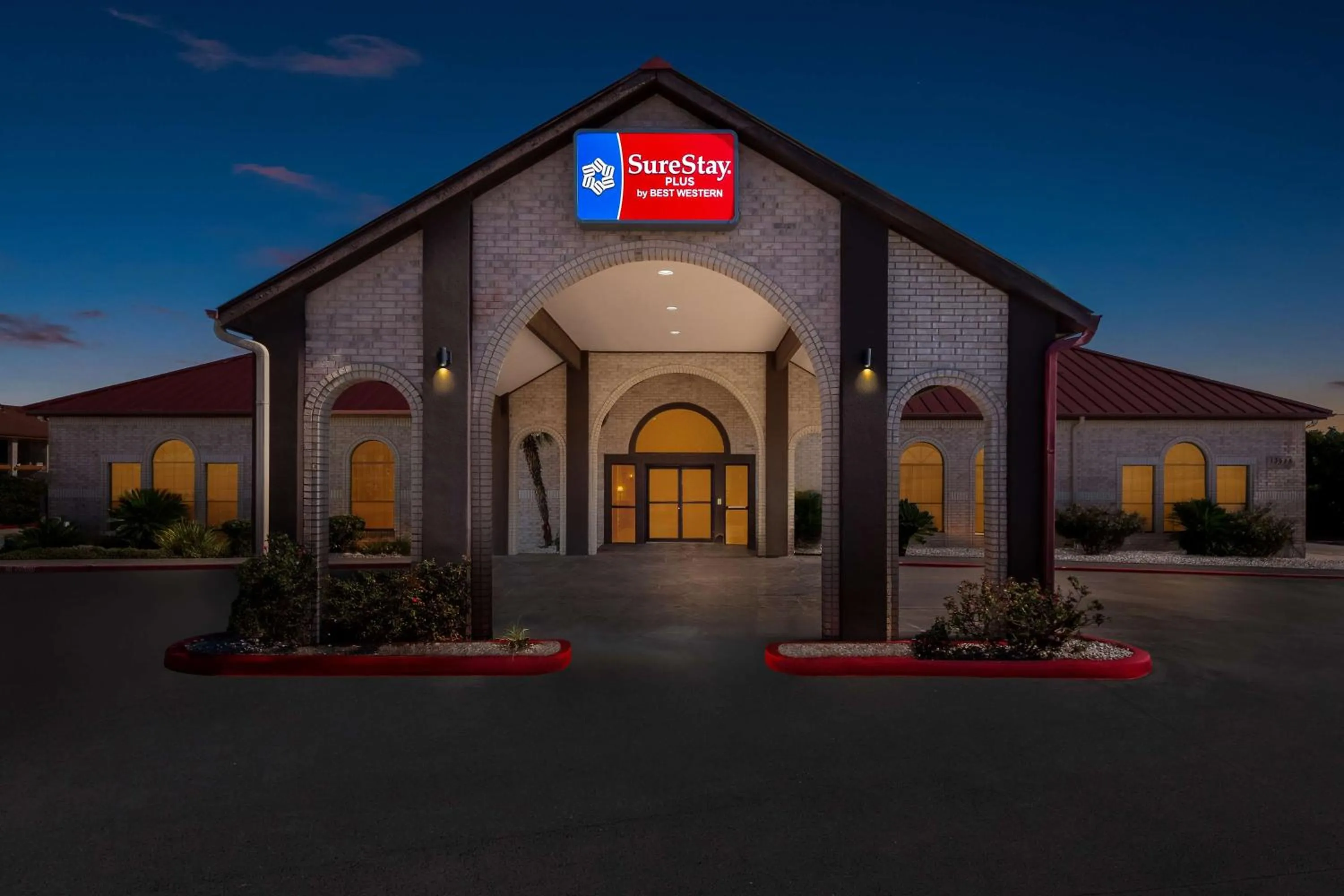 Property building in SureStay Plus by Best Western San Antonio Fiesta Inn
