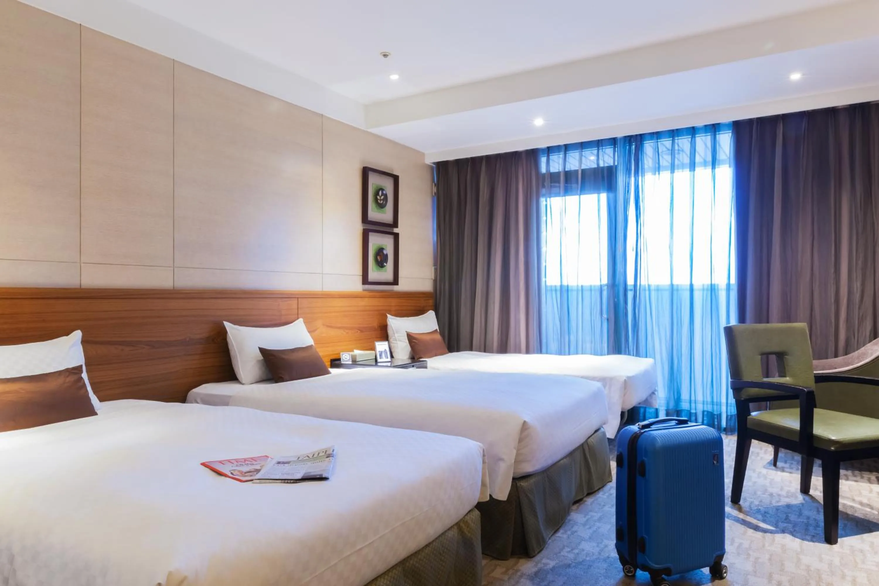 Bed in Pacific Business Hotel