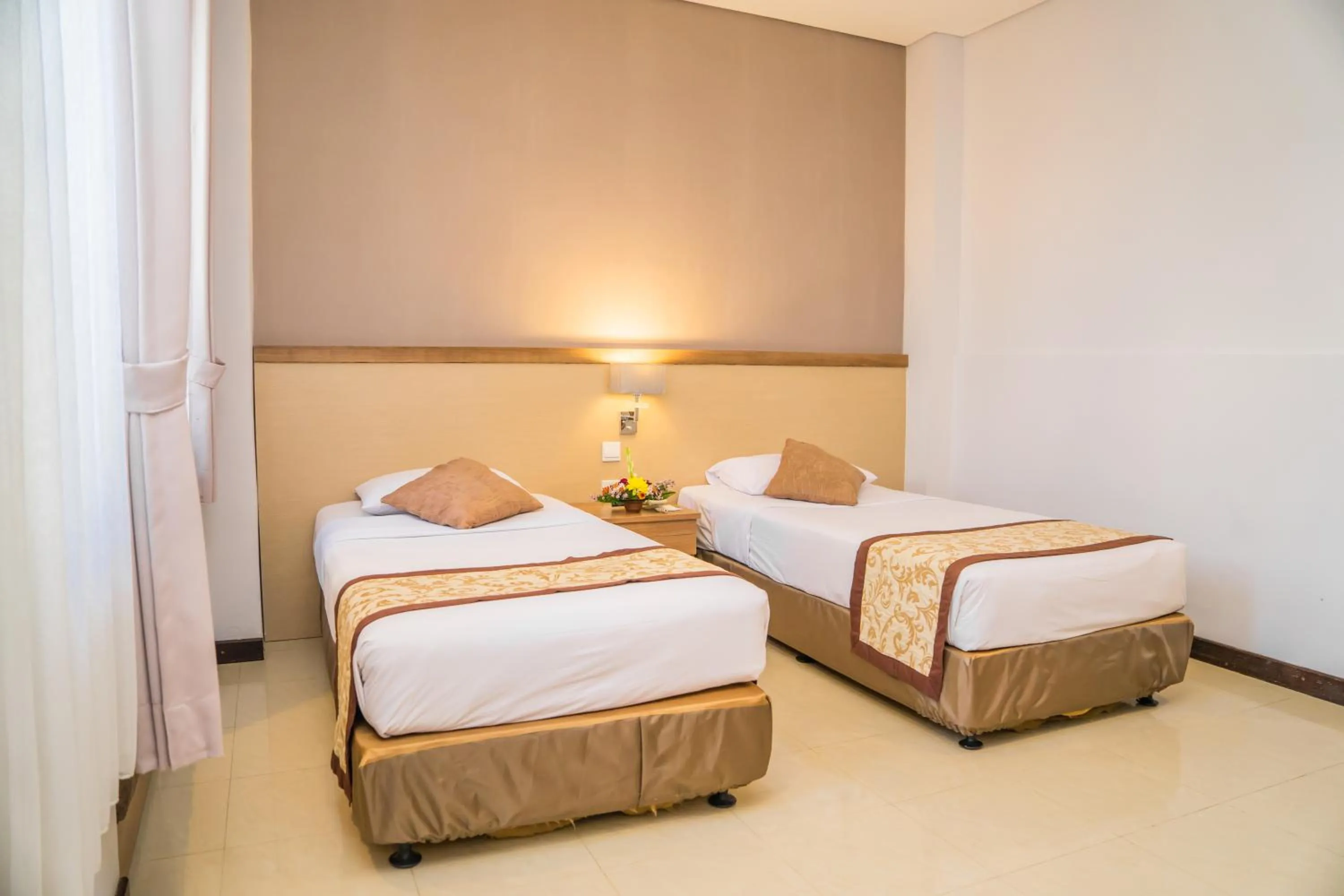 Bed in Hotel Puri Ayu