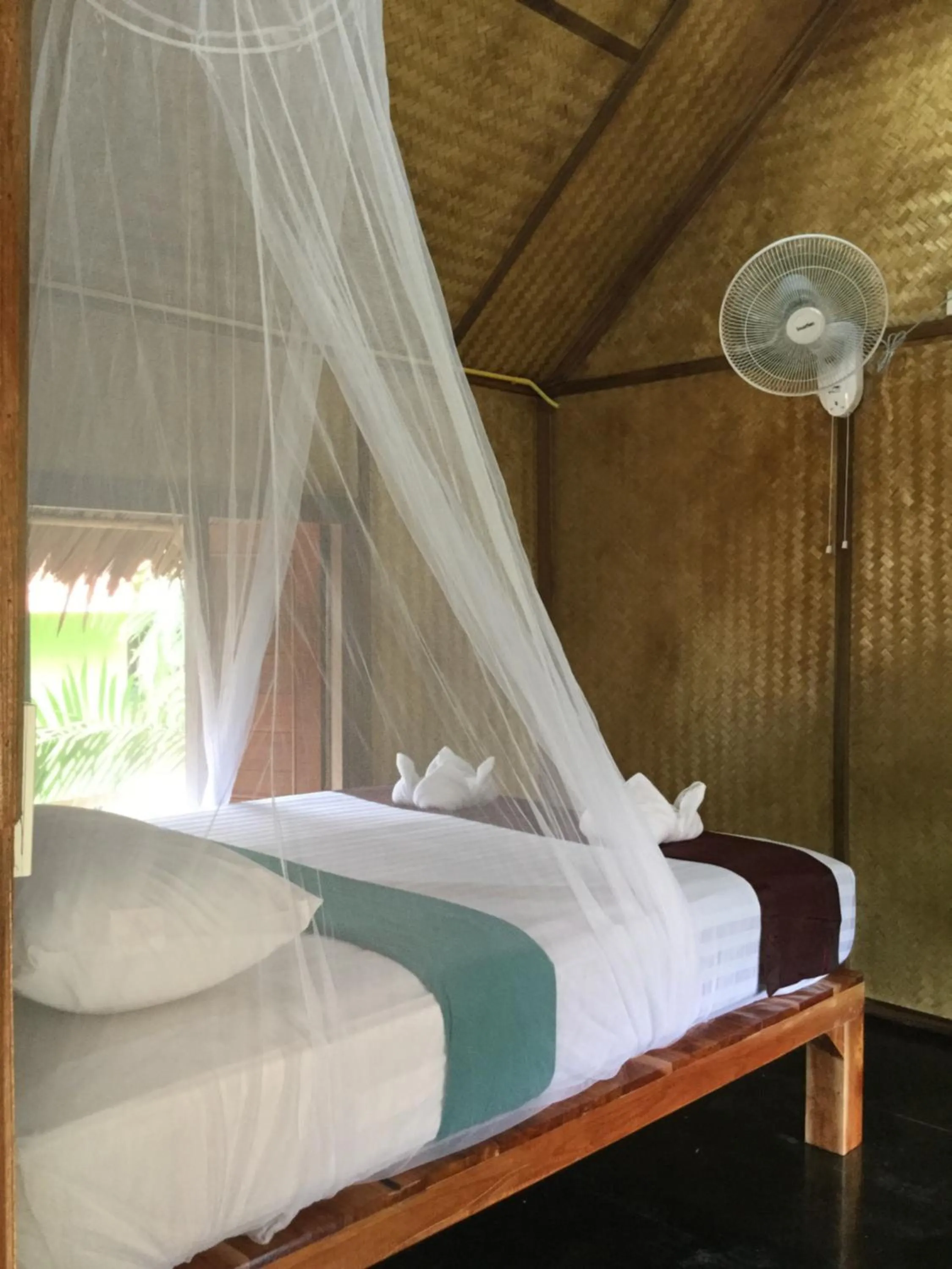 Bed in Khaosok Bamboo Huts Resort