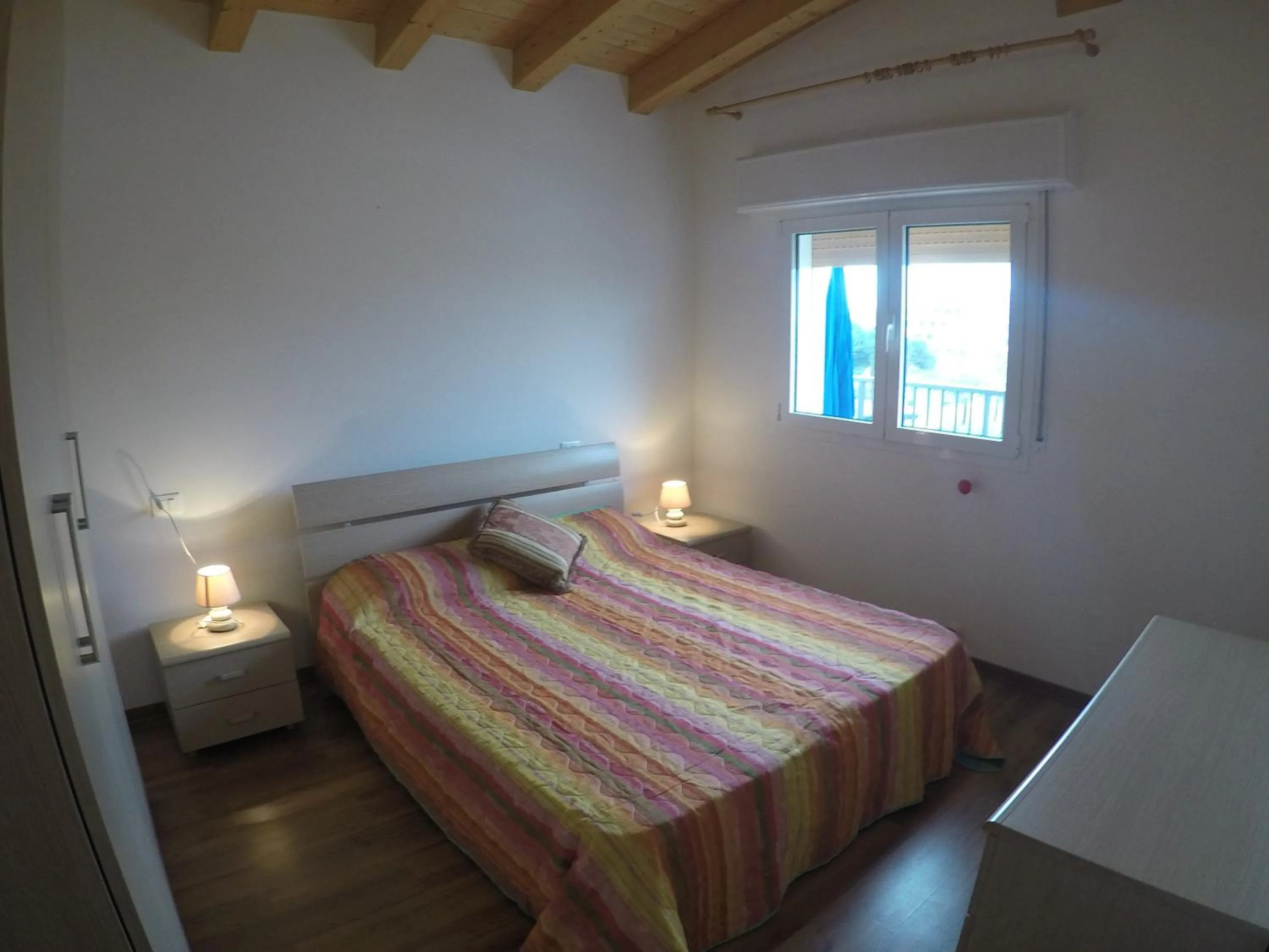 Bedroom in Residence Caorle Apartments - Agenzia Cocal