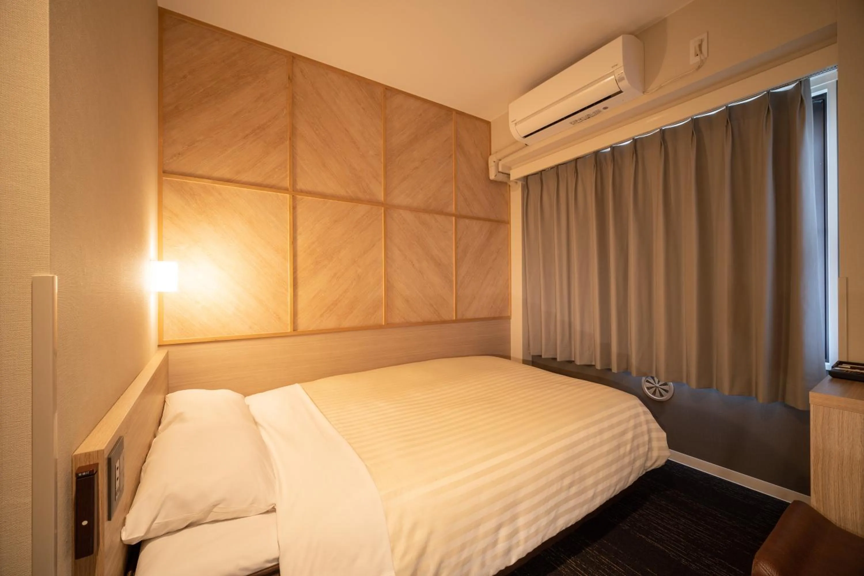 Bed in Super Hotel Kobe