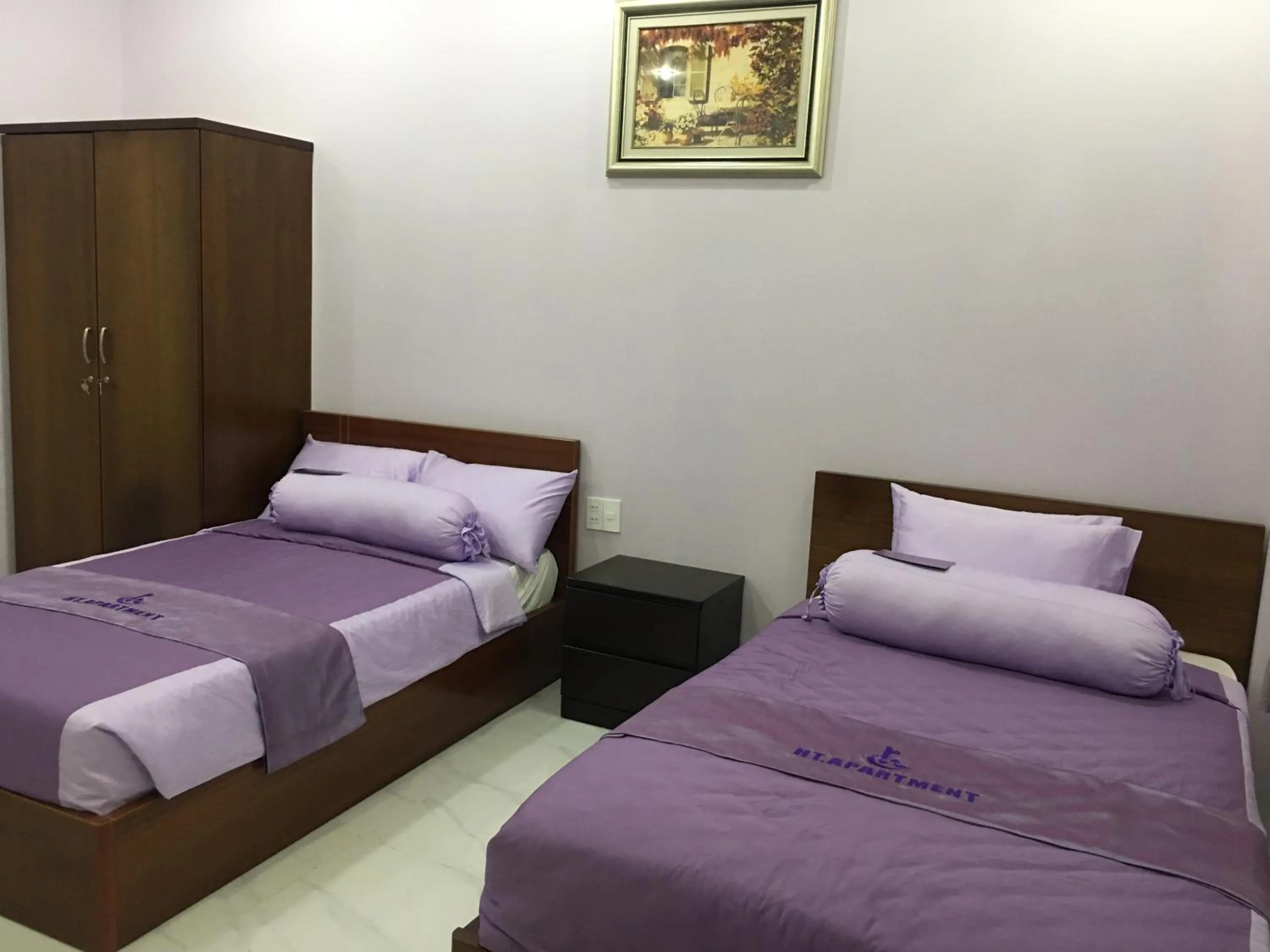 Bed in HT Hotel Apartment