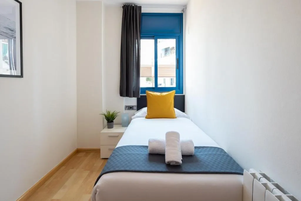 Bed in Lucas House Apartments by Sitges Group