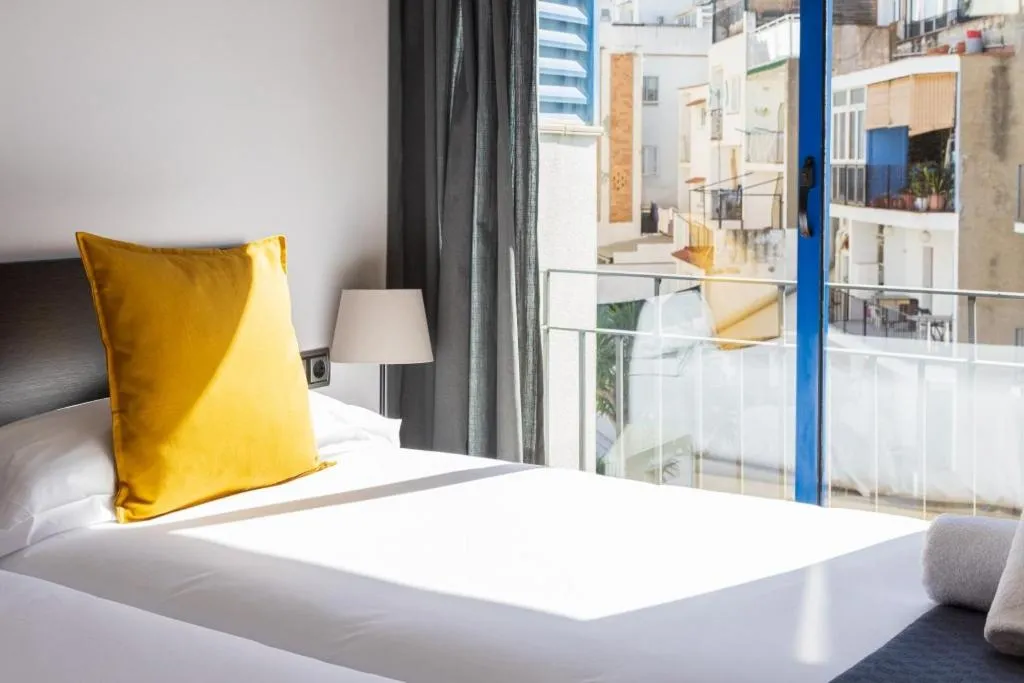 Bed in Lucas House Apartments by Sitges Group